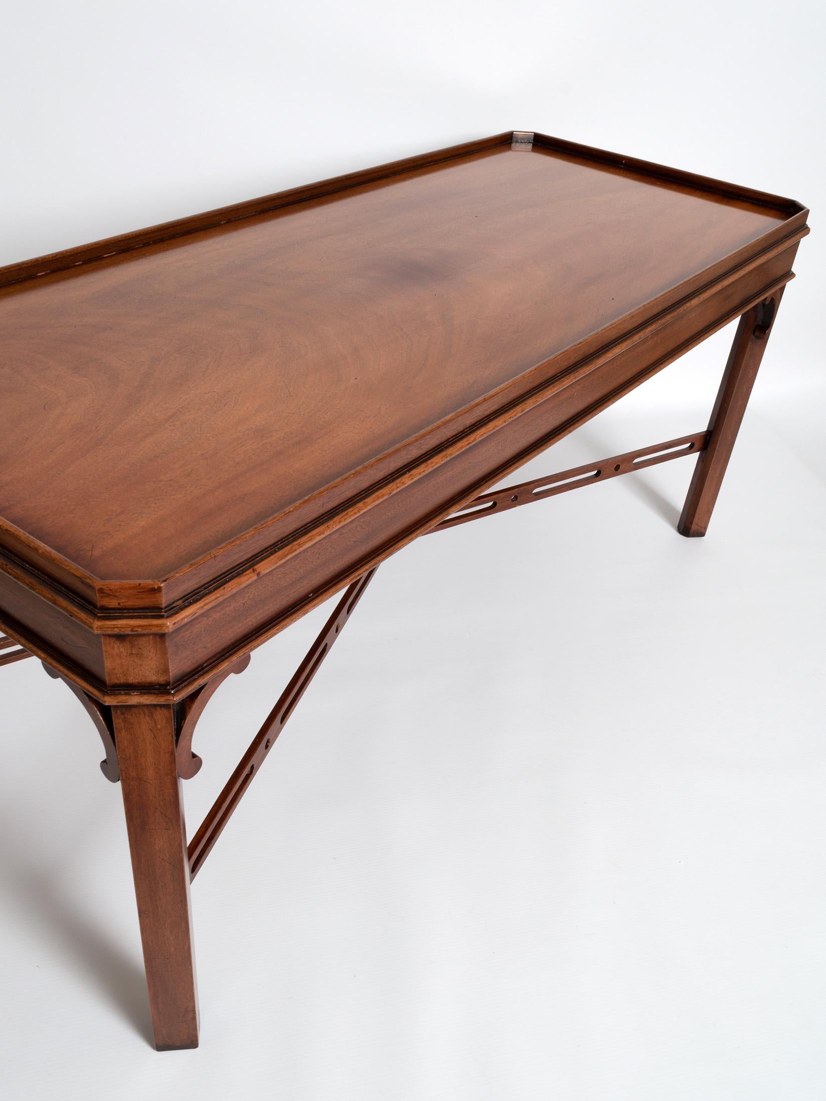 A solid mahogany George III Chippendale style coffee table by the fine English cabinet makers Brights of Nettlebed.

A fine piece with attractive fretwork detailing.

In very good condition commensurate of age and use.