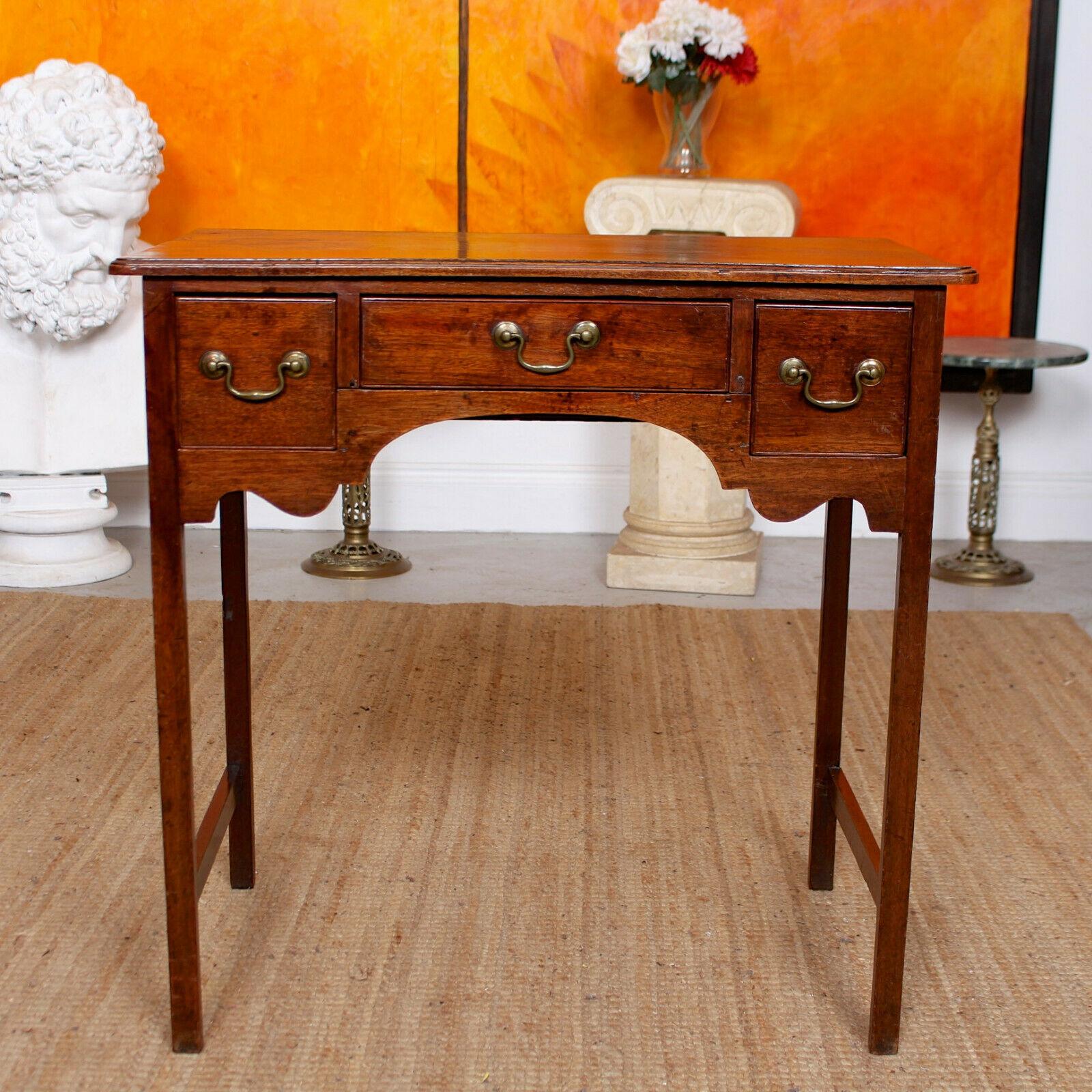 An impressive George III mahogany lowboy.
The rectangular top with shaped edges above three drawers and carved apron, raised on square section legs united by stretchers.
The mahogany boasting a rich patina and well figured wild grain.
England,