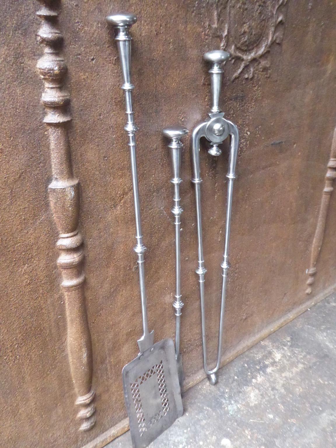 Fine set of three English Georgian fireplace tools made of polished steel, 18th-19th century. The fire tool set is in a good condition and is fully functional.








