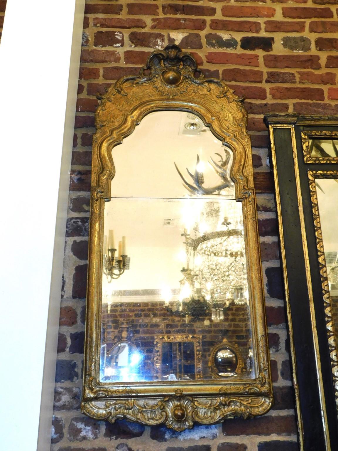 English Georgian Acanthus foliage medallion crest gilt wood & gesso scrolled foliage border two plate beveled wall mirror. Mirror retains the original beveled looking glass and wood backing. Mid-18th Century