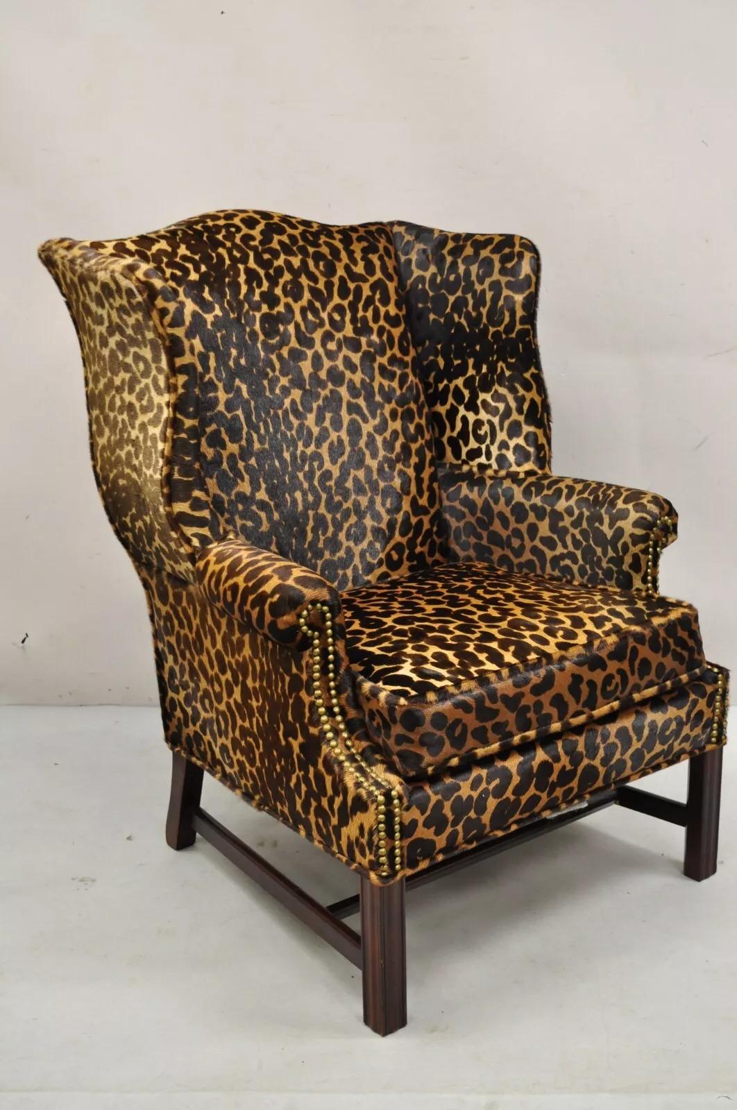 Vintage English Georgian Style Leopard/Cheetah Hair on Hide Leather Upholstery Wingback Chair with Mahogany Wood Frame and Nailhead Trim. Circa Mid 20th Century. Measurements: 40
