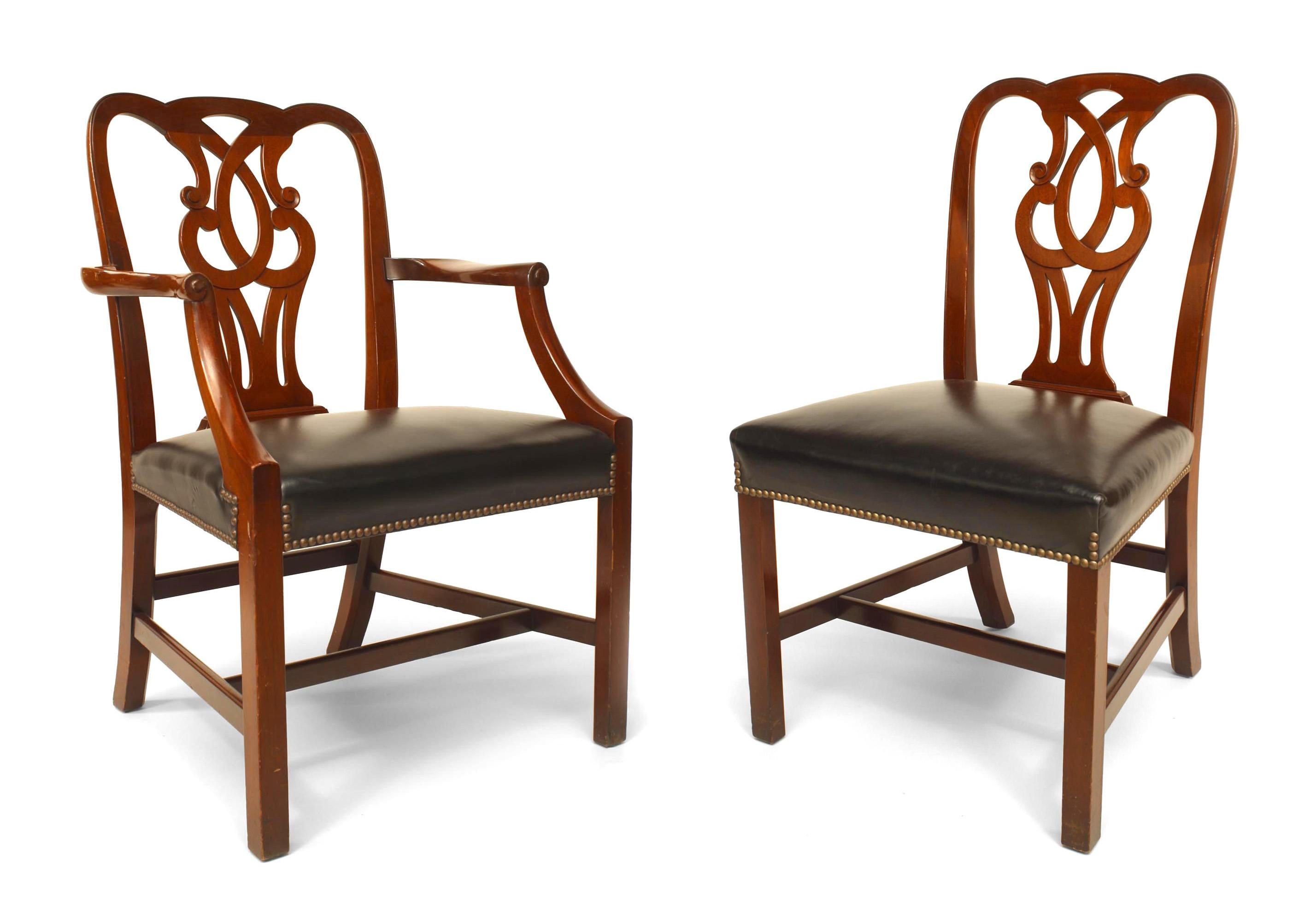 Set of 12 English Georgian style (20th century) mahogany chairs. 2 arm/10 sides with open scroll back and black leather seat. Side: 22½