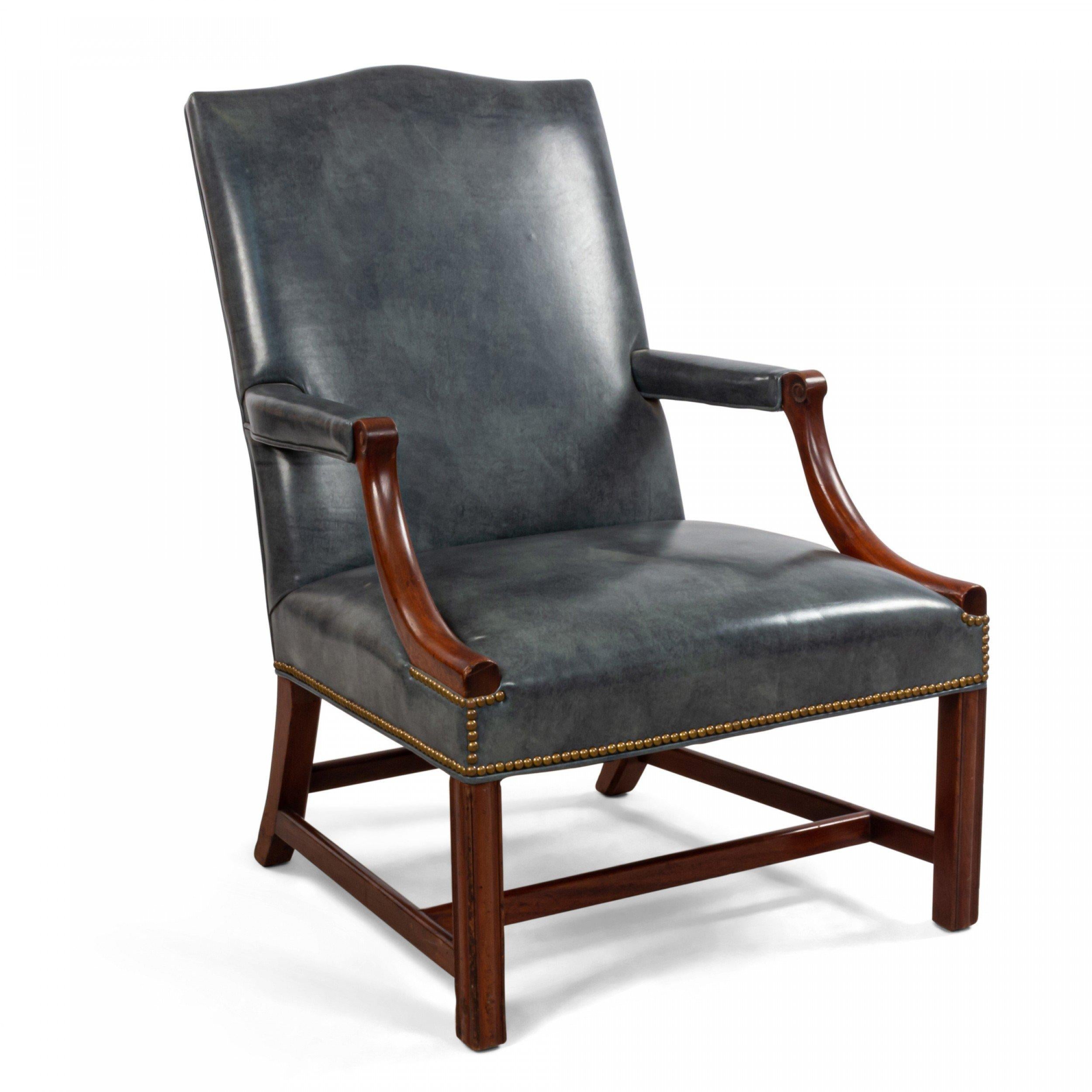 English Georgian style (20th Cent) mahogany open arm chair with shaped back and upholstered in a leather style blue/grey.
  