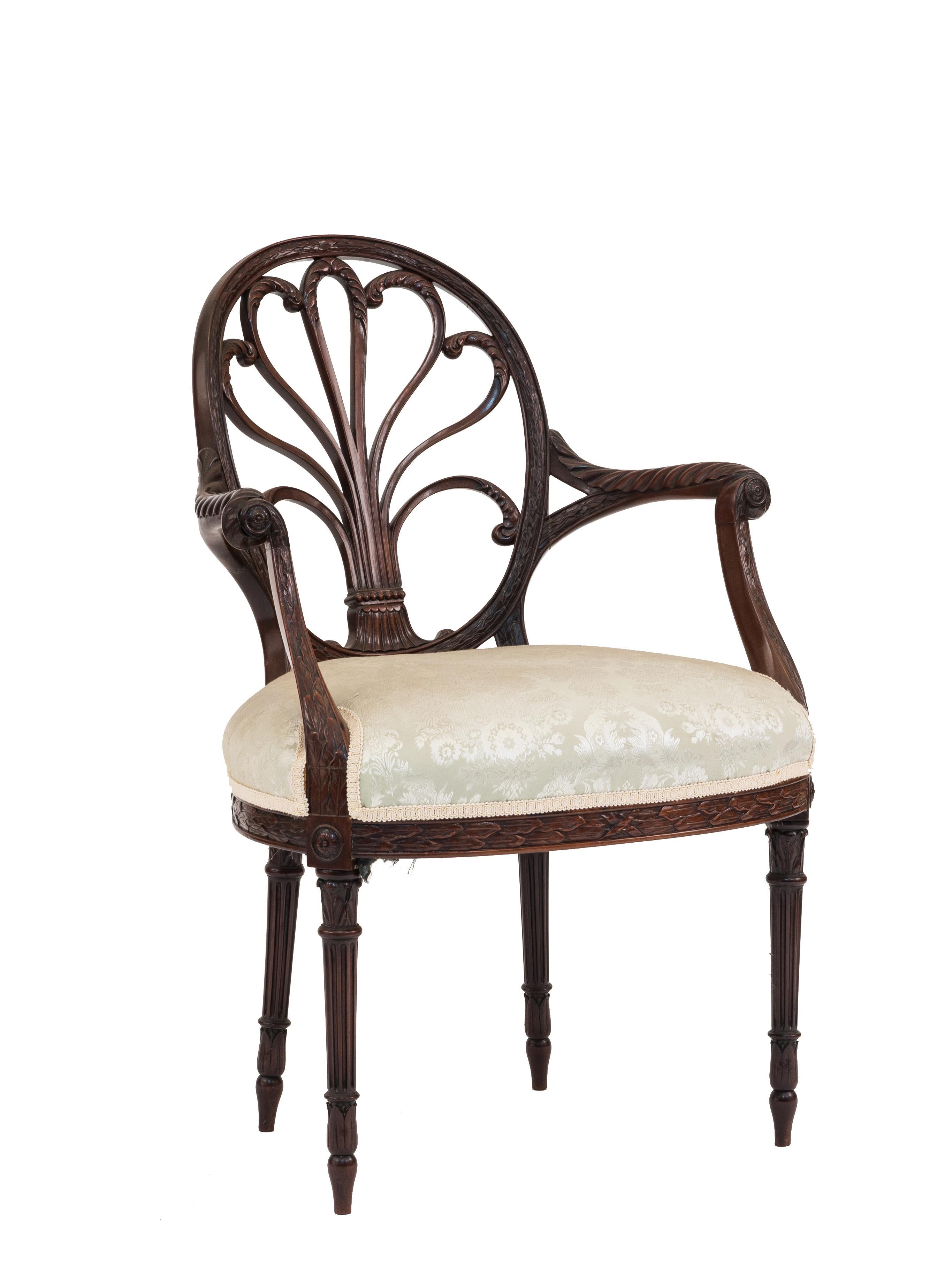 Pair of English Georgian style mahogany armchairs with carved palmette design back on fluted legs with upholstered seat (19th century.)
