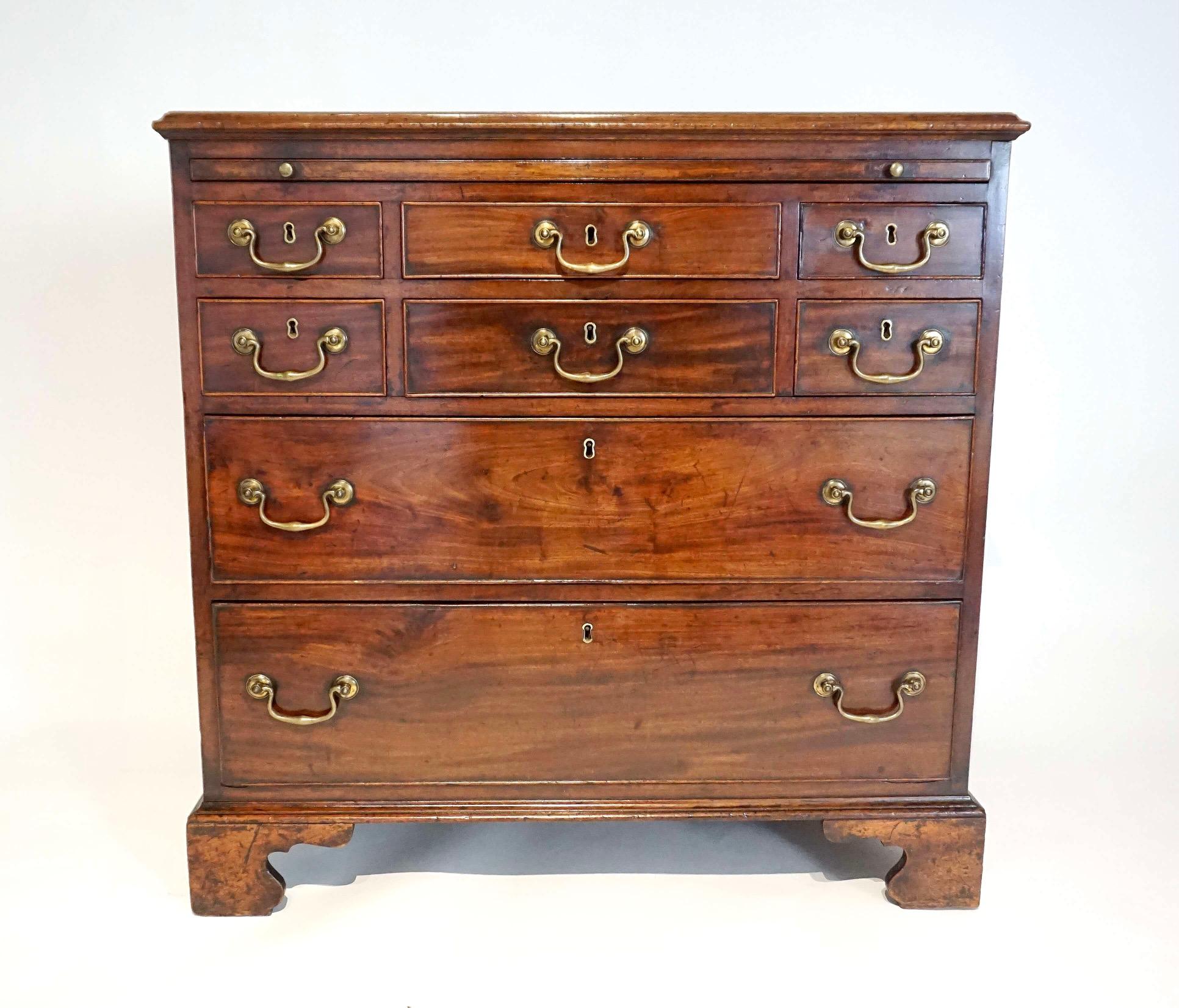 An extremely fine and elegant English late George II, early George III period chest of unusual form having mahogany case with brushing slide above six upper drawers over two lower all with original brass hardware. A truly exceptional piece with