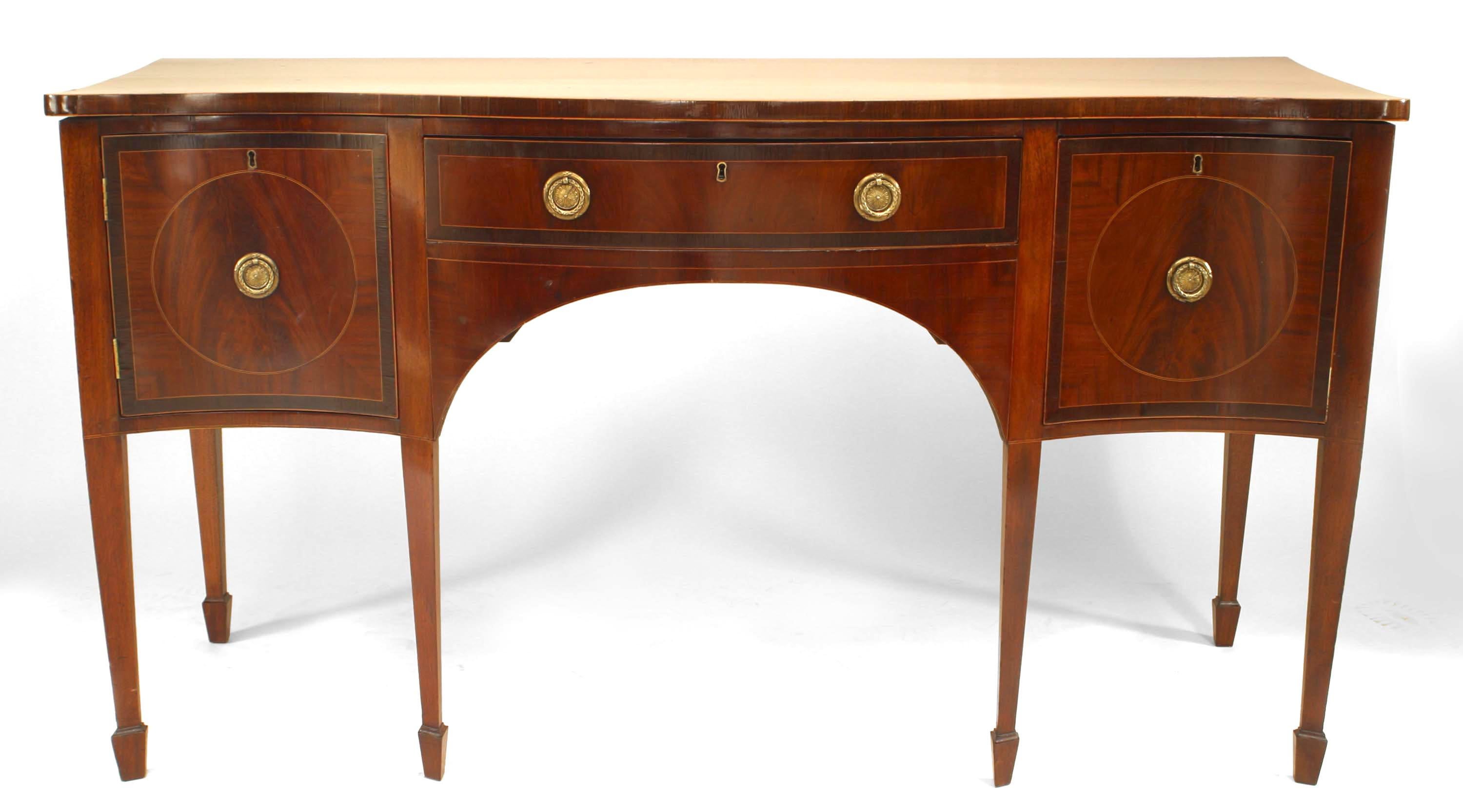 English Georgian mahogany bowfront sideboard with inlaid satinwood banding and brass wreath design drawer handles and supported on shaped spade legs and feet.

 