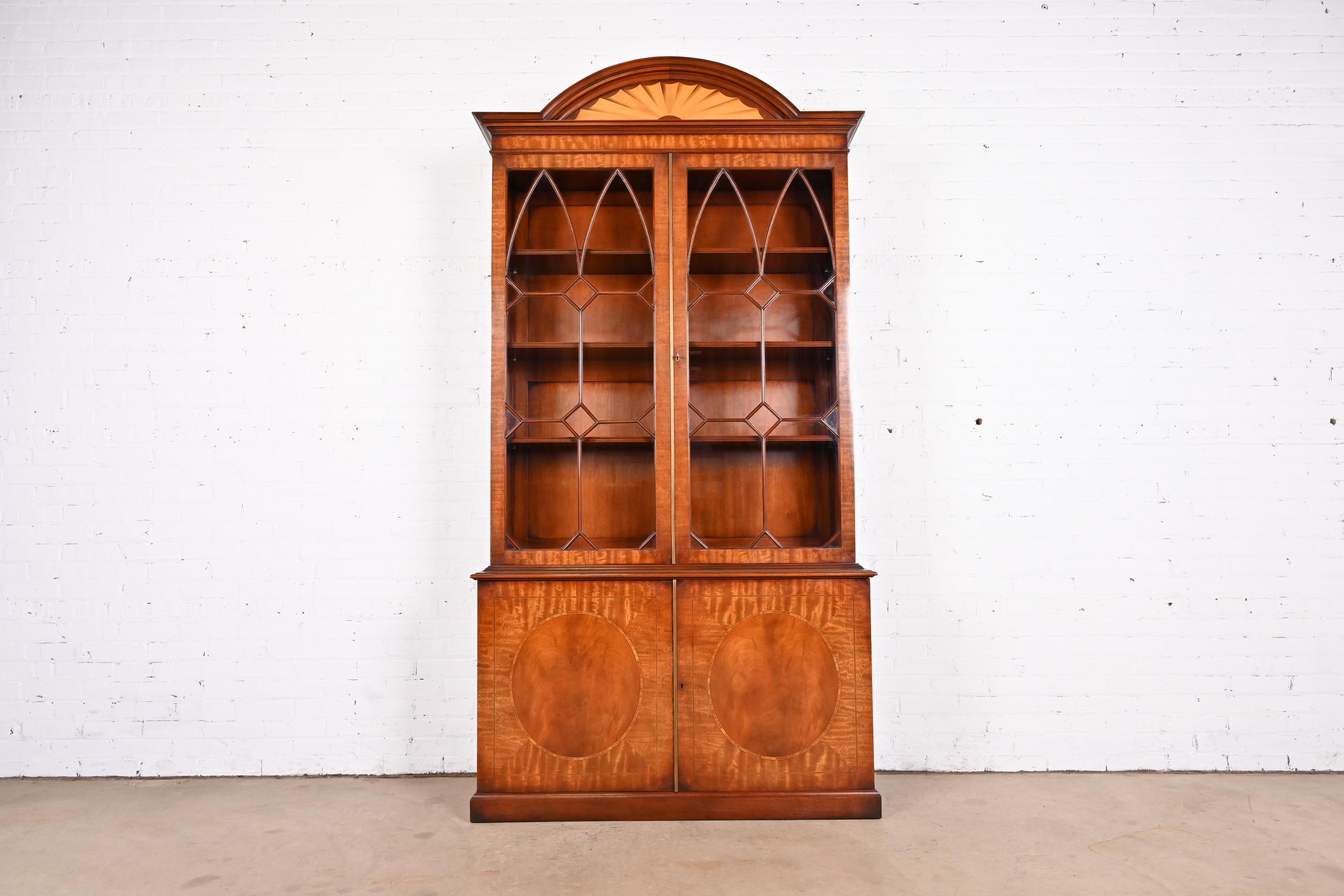 A gorgeous English Georgian or Sheraton style breakfront bookcase cabinet

By Restall Brown & Clennell

England, Late 20th Century

Gorgeous mahogany and satinwood, with mullioned glass front doors. Cabinet locks, and key is included.

Measures: