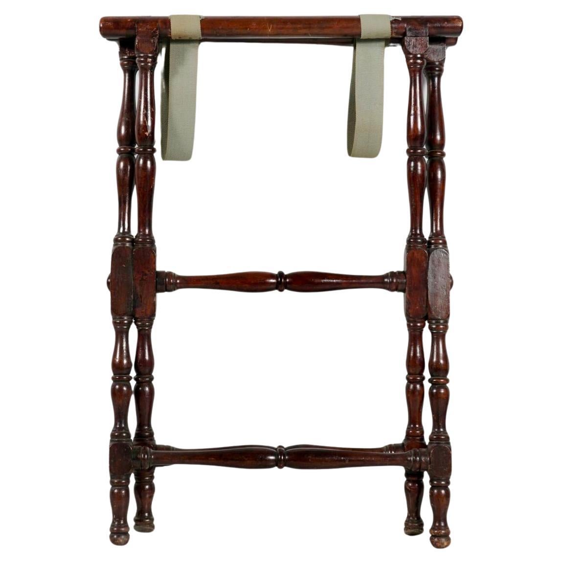 English Georgian Mahogany Butler's Tray and Folding Stand. Removable tray features open handles and dovetail corners. Tray has an elegant silhouette with curved outline, and rests on a folding stand. Stand has wonderfully shaped turned legs that can