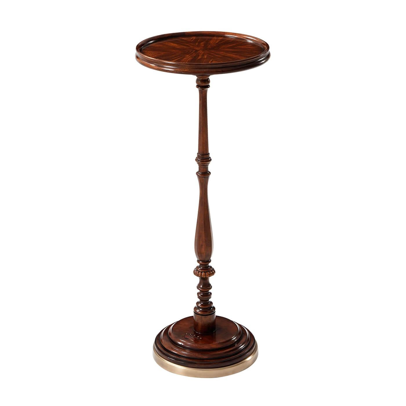An English Georgian style mahogany candle stand, the circular molded edge top on a delicately turned baluster column terminating in a dished and molded circular brass bound platform base.

Dimensions: 11.5