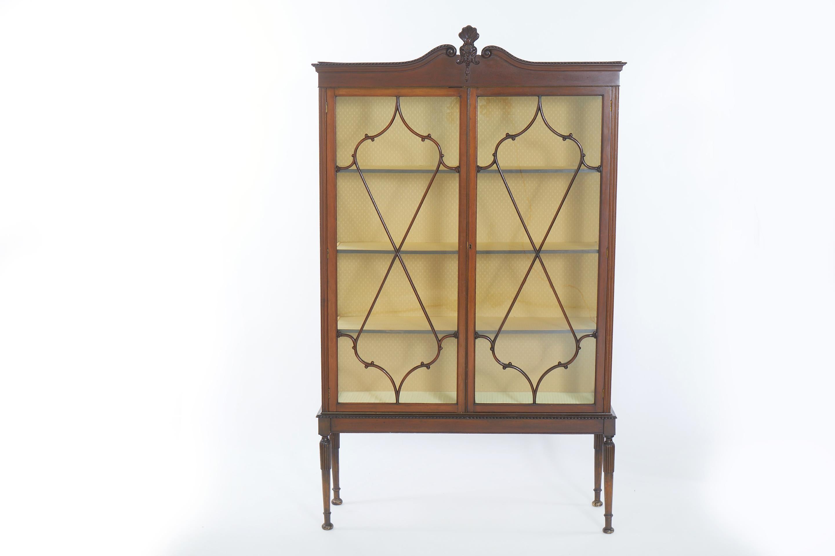 English Georgian style mahogany display china cabinet / bookcase . The cabinet features individual panes of glass, pencil inlay, solid wood construction, beautiful wood grain, with two swing doors. The cabinet is in good antique condition with
