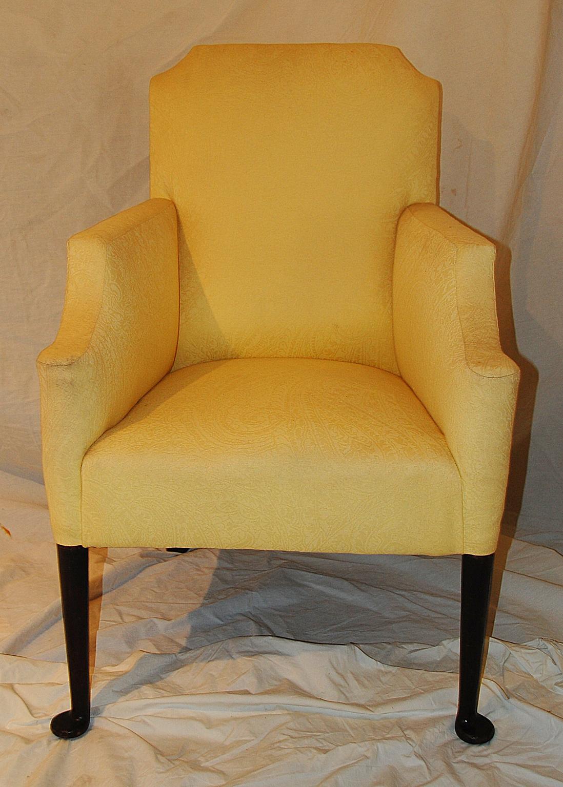 English Georgian mahogany period upholstered lounging chair, with carved pad feet, shaped back and yellow woven upholstery. The upholstery is probably about 5 years old. This small scale lounging chair is easily placed in a bedroom, living room or