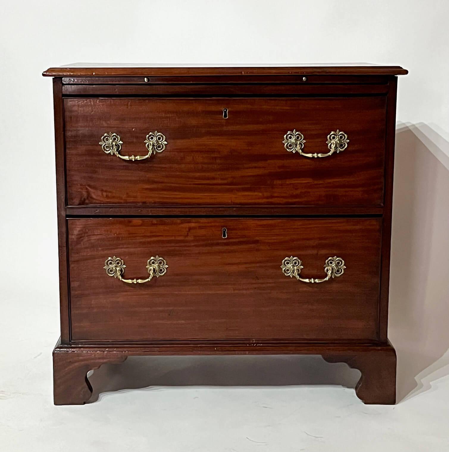 A fine English circa 1760, late George II, early George III period bachelor's chest of rare 'hat chest' or 'bonnet chest' configuration, the luminescent mahogany case of rectangular form having top brushing slide above two deep drawers with