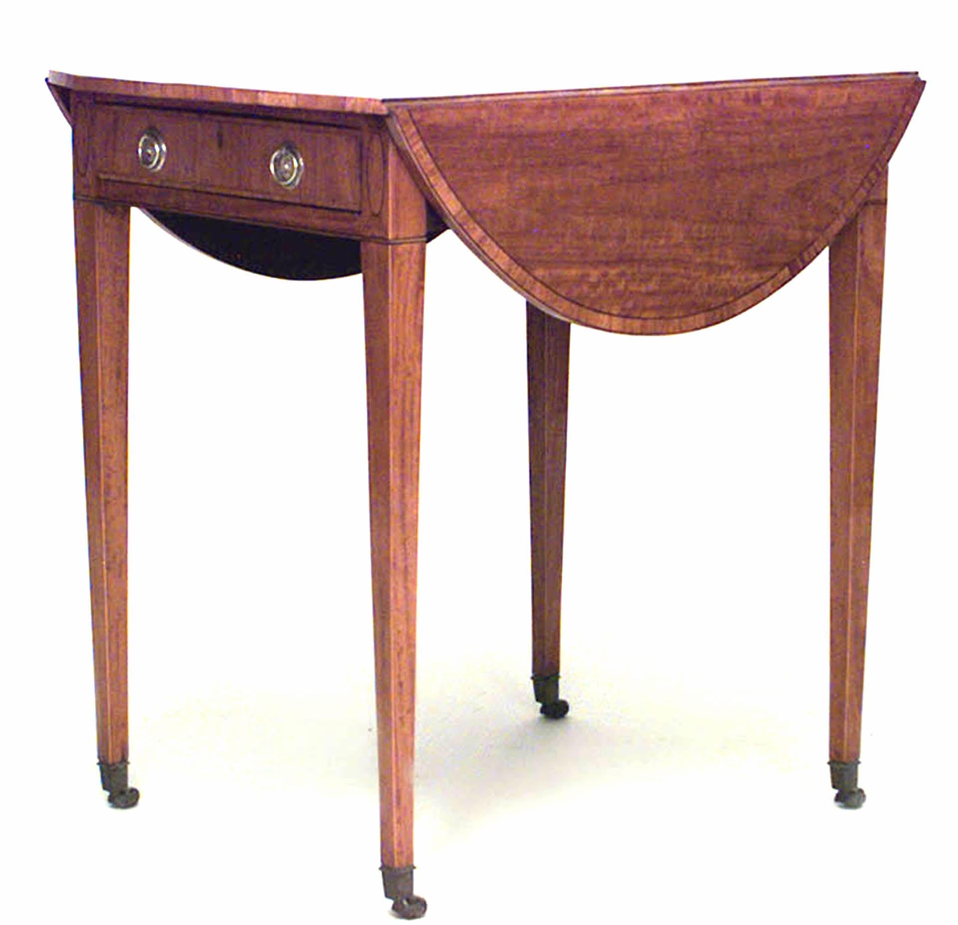 English Georgian (Circa 1775) marquetry, satinwood Pembroke table with shell-inlaid tulipwood banded oval top above a frieze drawer, on brass casters.
