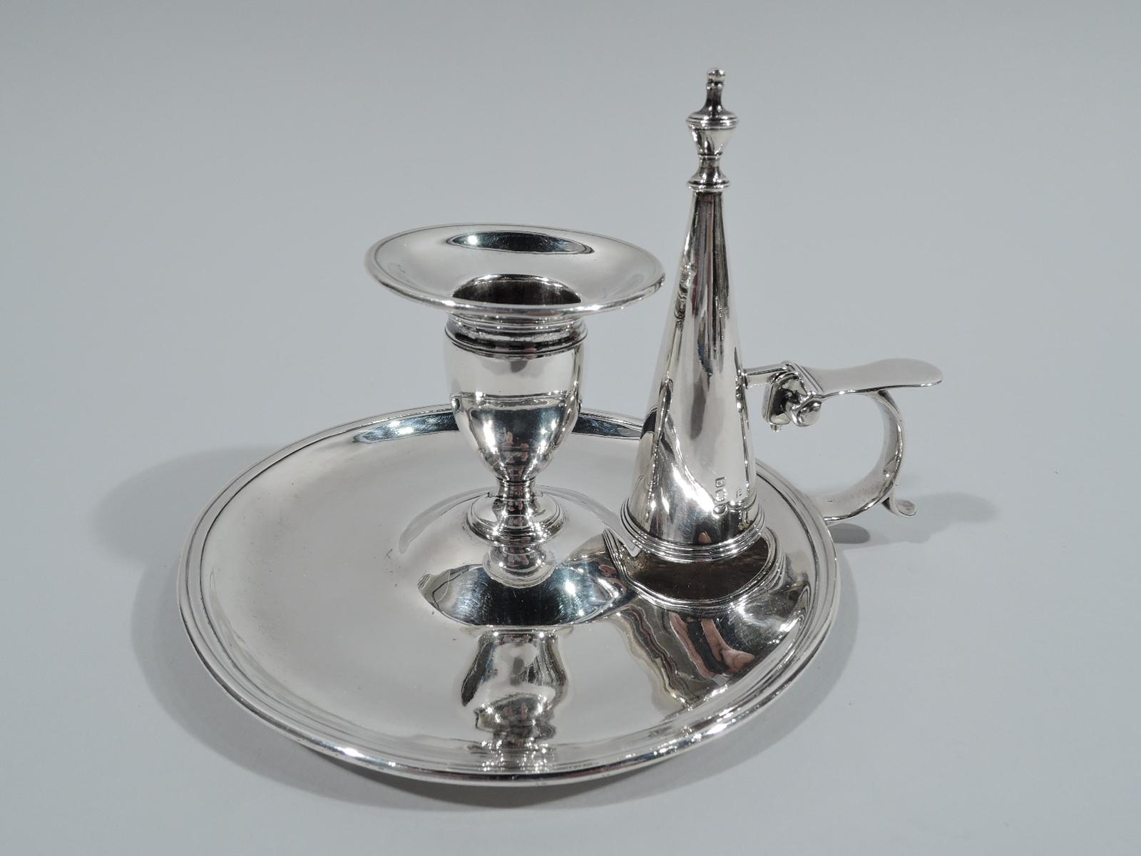 English Georgian neoclassical sterling silver chamberstick, 1791. Central ovoid socket on raised foot mounted to raised center of round and molded saucer. Conical snuffer with vasiform finial and bracket mount set in capped c-scroll handle. Fully