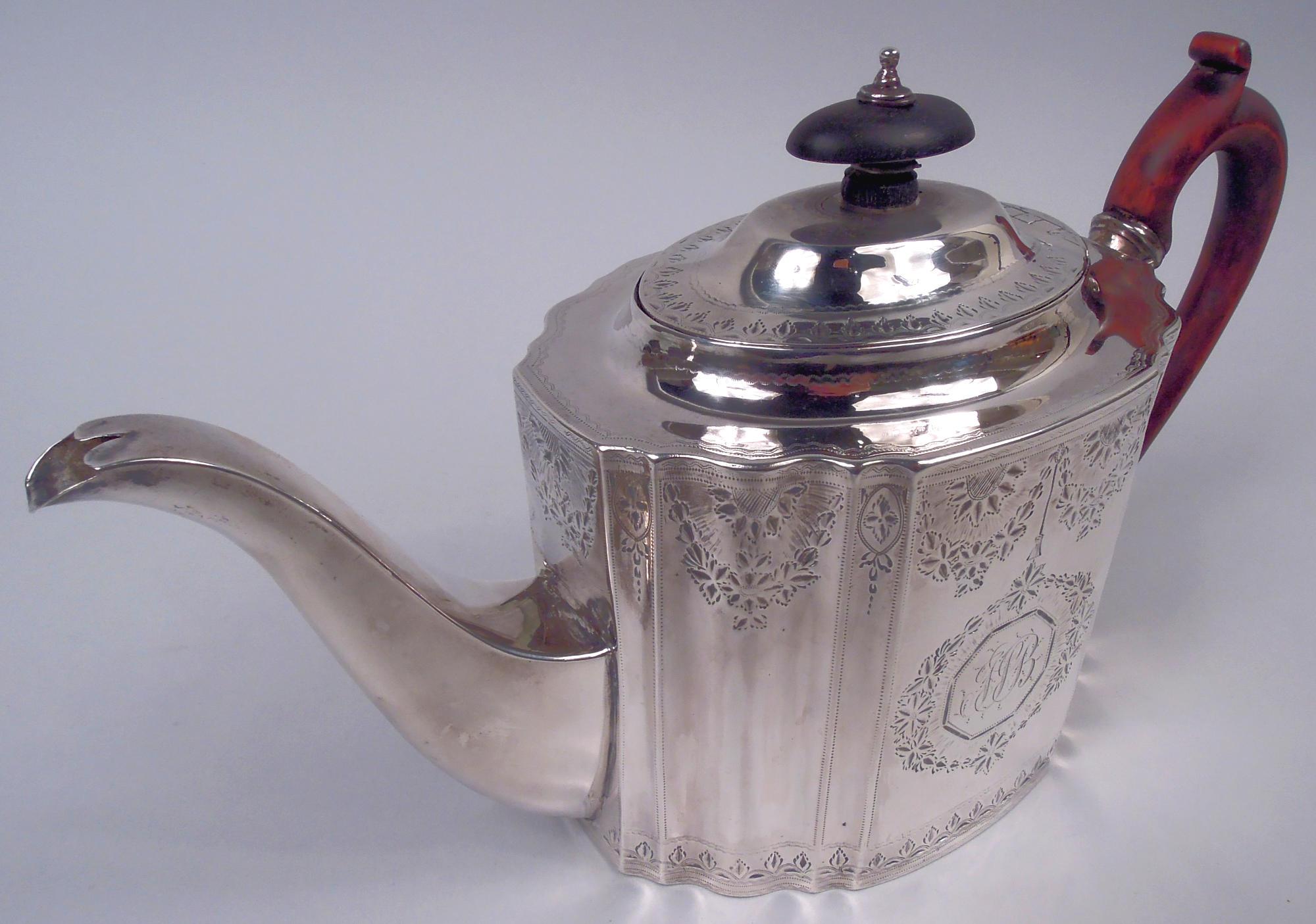 Théière en argent sterling de style géorgien néoclassique anglais, 1792. Ovale cannelé aux côtés droits et aux extrémités tronquées ; bec effilé et rectiligne à volute en S et poignée en bois teinté à boucles hautes et capuchon. Le couvercle est
