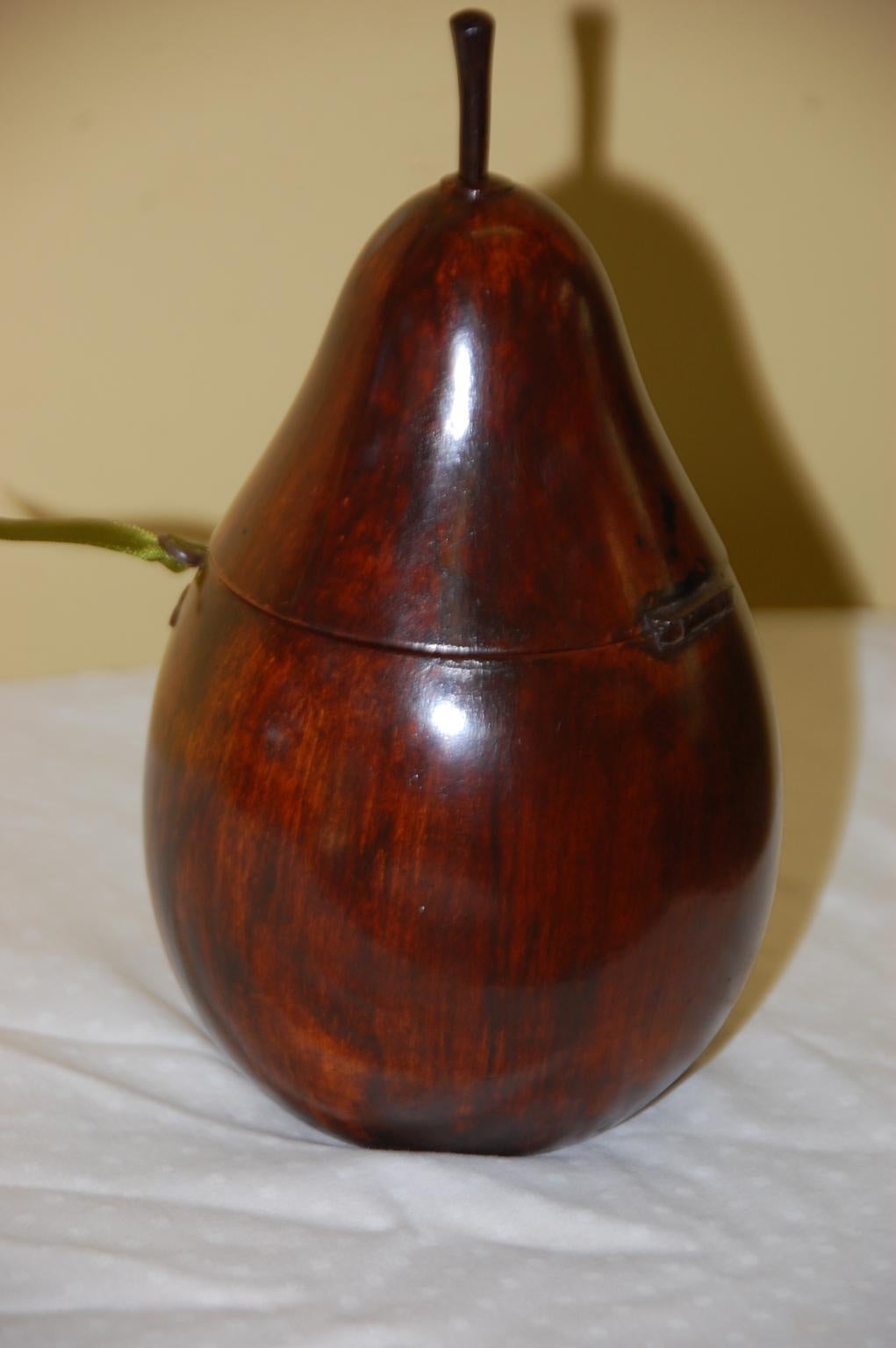 English Georgian pear tea caddy in pear wood, hand carved from a single block of wood, complete with original iron escutcheon, hinge, key and stem, retaining remnants of its original foil lining, circa 1800.