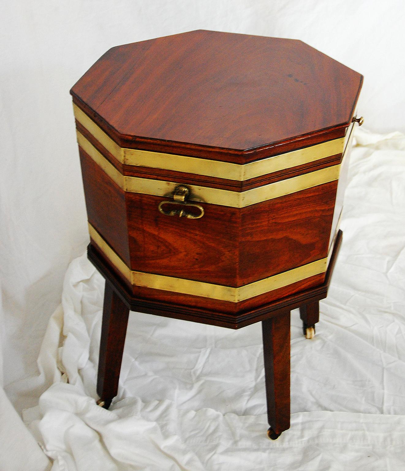 English Georgian period Chippendale mahogany octagonal cellarette on original base with brass side handles and brass strapping. This cellarette retains its original interior with divisions for bottles and original lining. There is a professional