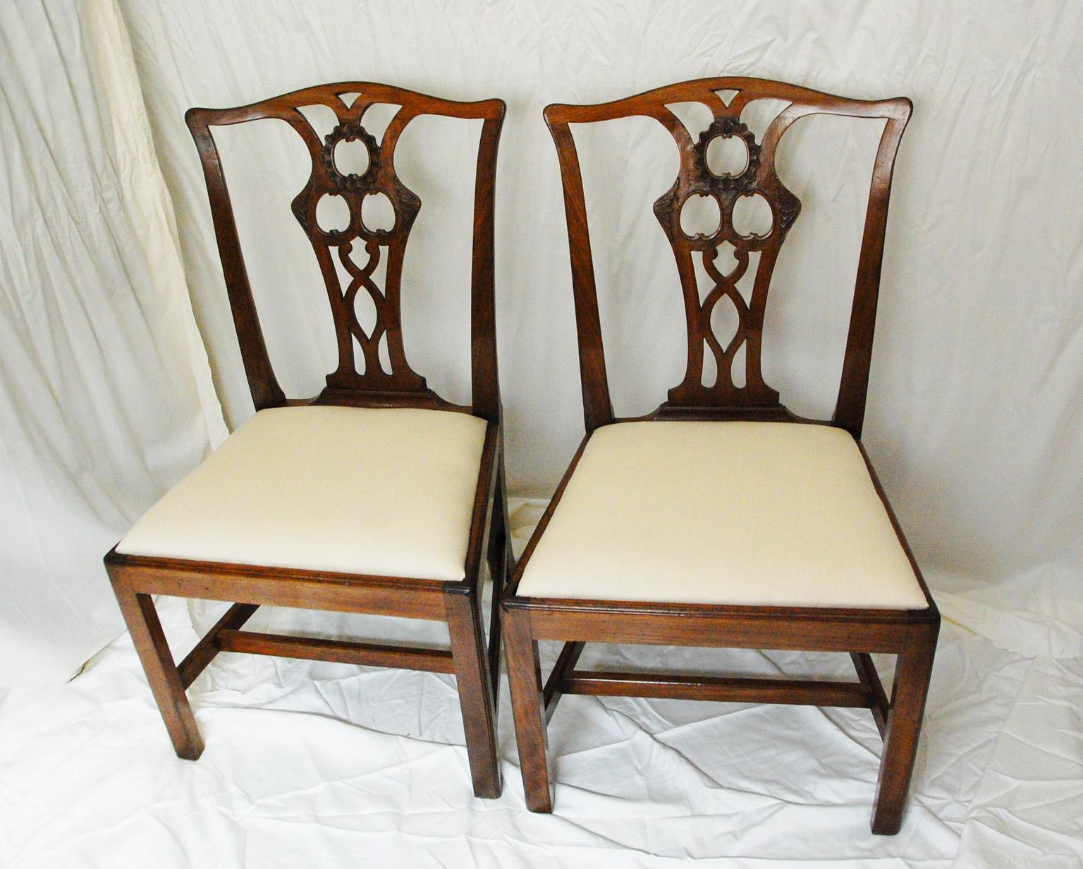 English Georgian Chippendale Period pair of carved mahogany sidechairs with slip seats, molded square legs, H stretcher and elegantly carved back. They have been through our workshop, so all joints are tight and firm. At some point in the last 100
