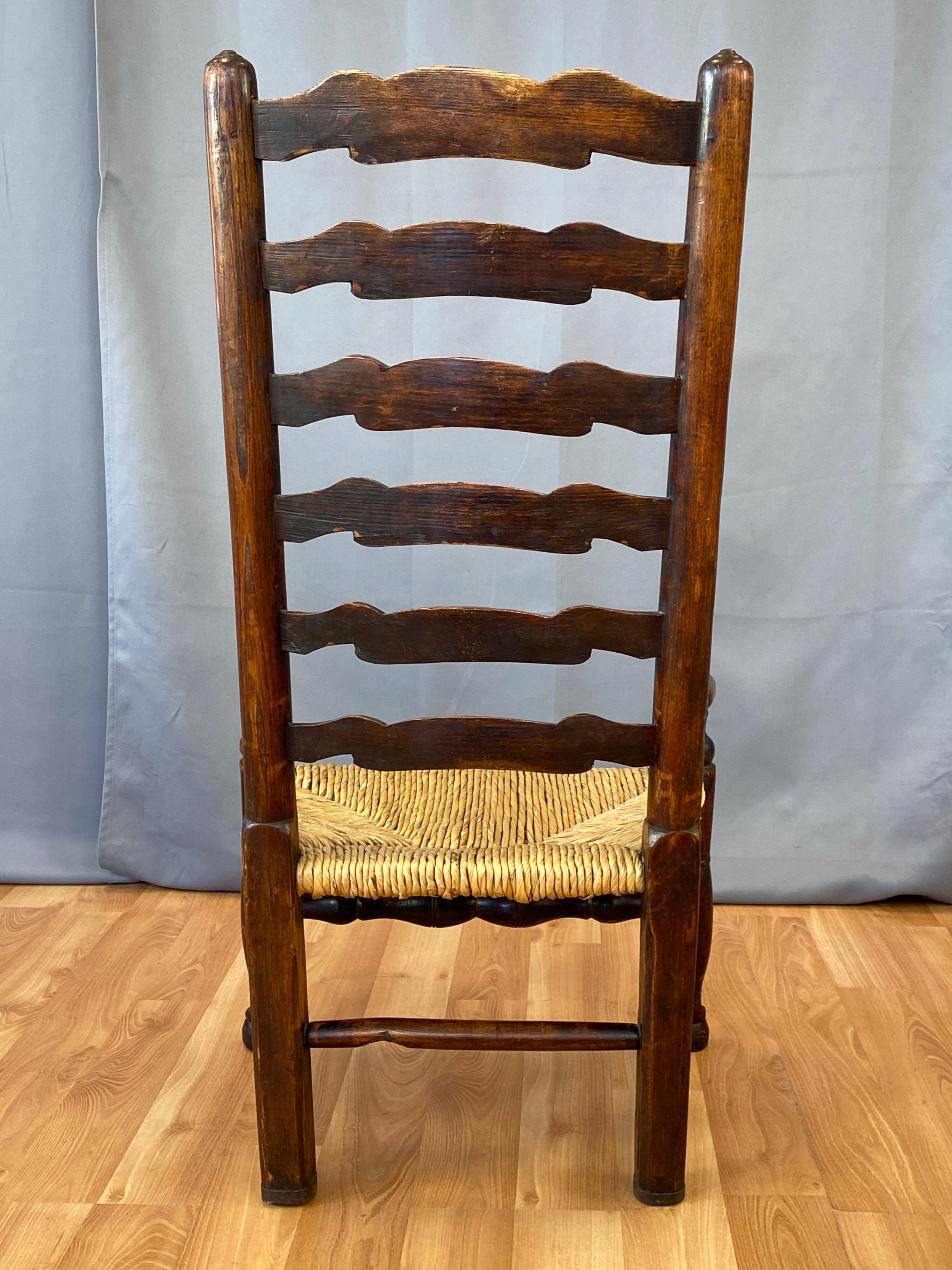 Hand-Woven English Georgian Period Elm Ladderback Fireside Armchair with Rush Seat, c. 1800 For Sale