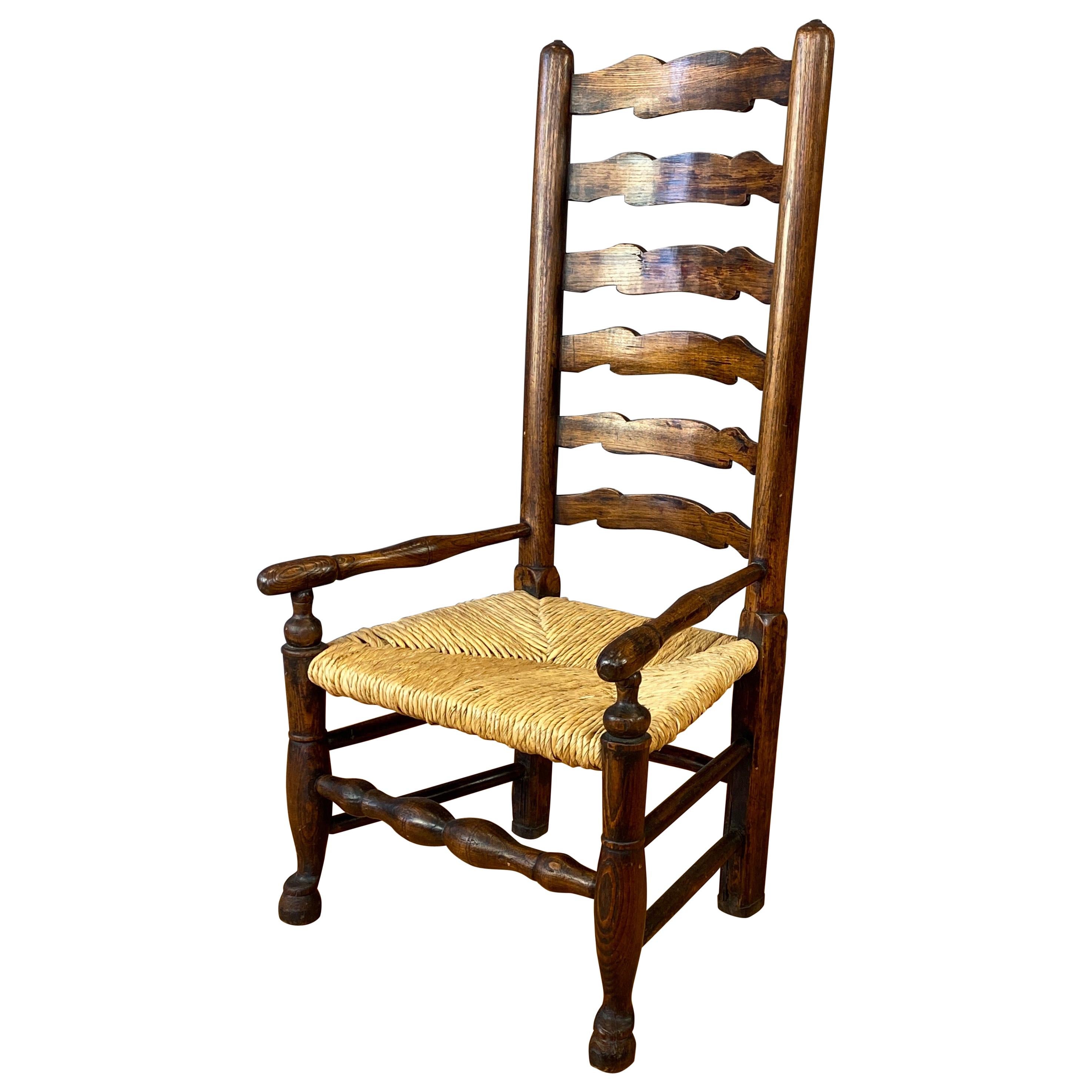 English Georgian Period Elm Ladderback Fireside Armchair with Rush Seat, c. 1800 For Sale