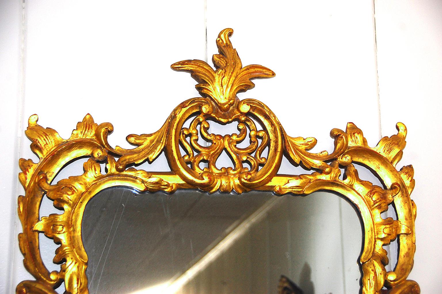 Englischer Spiegel aus der Zeit Georgs III., mit Blattgold beschnitzt, mit Blattwerk- und Blumenmotiven, eleganten Durchbrüchen und Fließen um den Spiegel herum, von einem Meisterschnitzer gefertigt, um 1790.