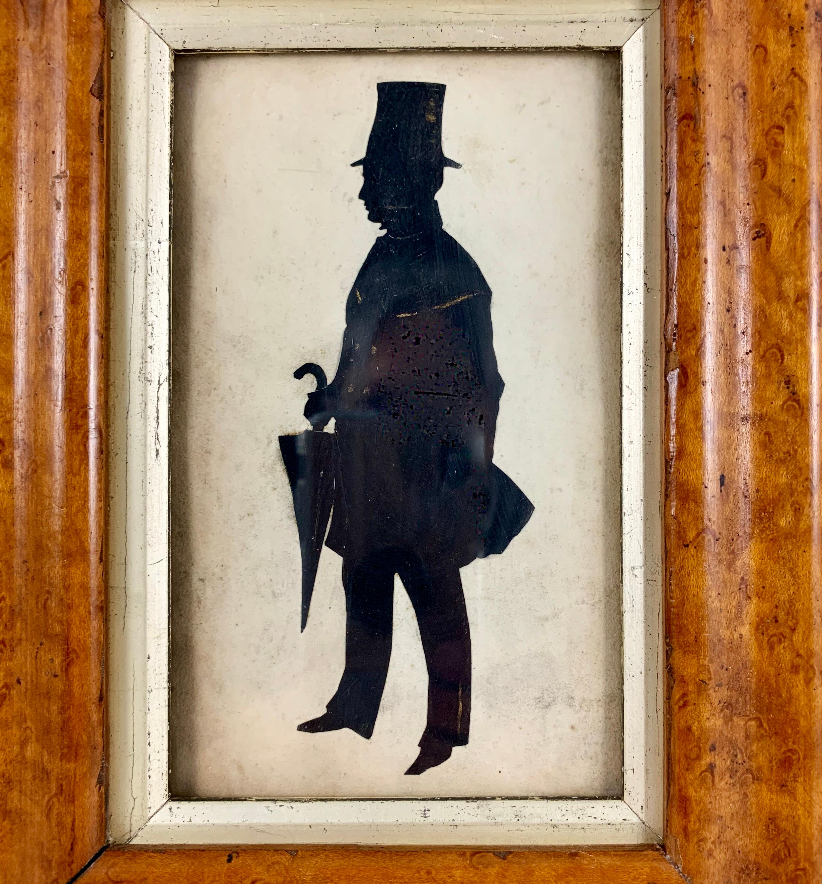 An original British School Georgian Period silhouette, circa 1850-1880, mounted in a period Maplewood frame. These watercolor silhouettes were largely painted by young girls from aristocratic families during the English Regency and Georgian periods.