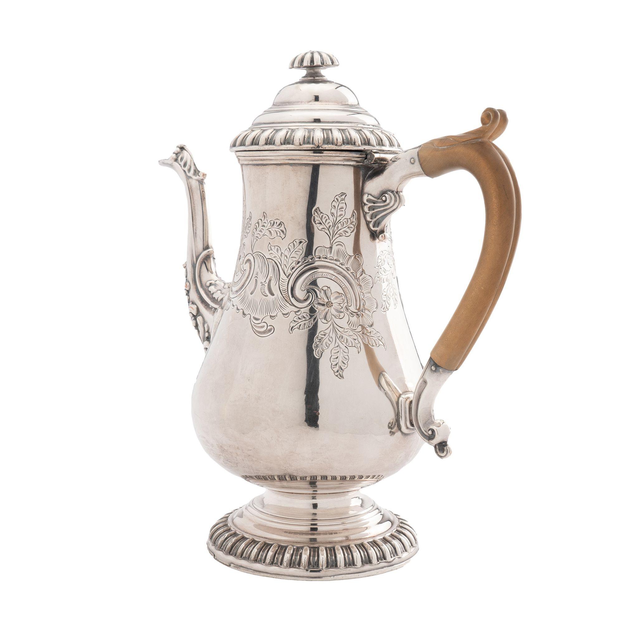 English Old Sheffield Rococo pyriform coffee pot with carved boxwood handle. The foot, lid rim, and lid finial are cast in a reel molding. Rococo engraving and developed Rococo spout are indicative of its mid 18th Century English