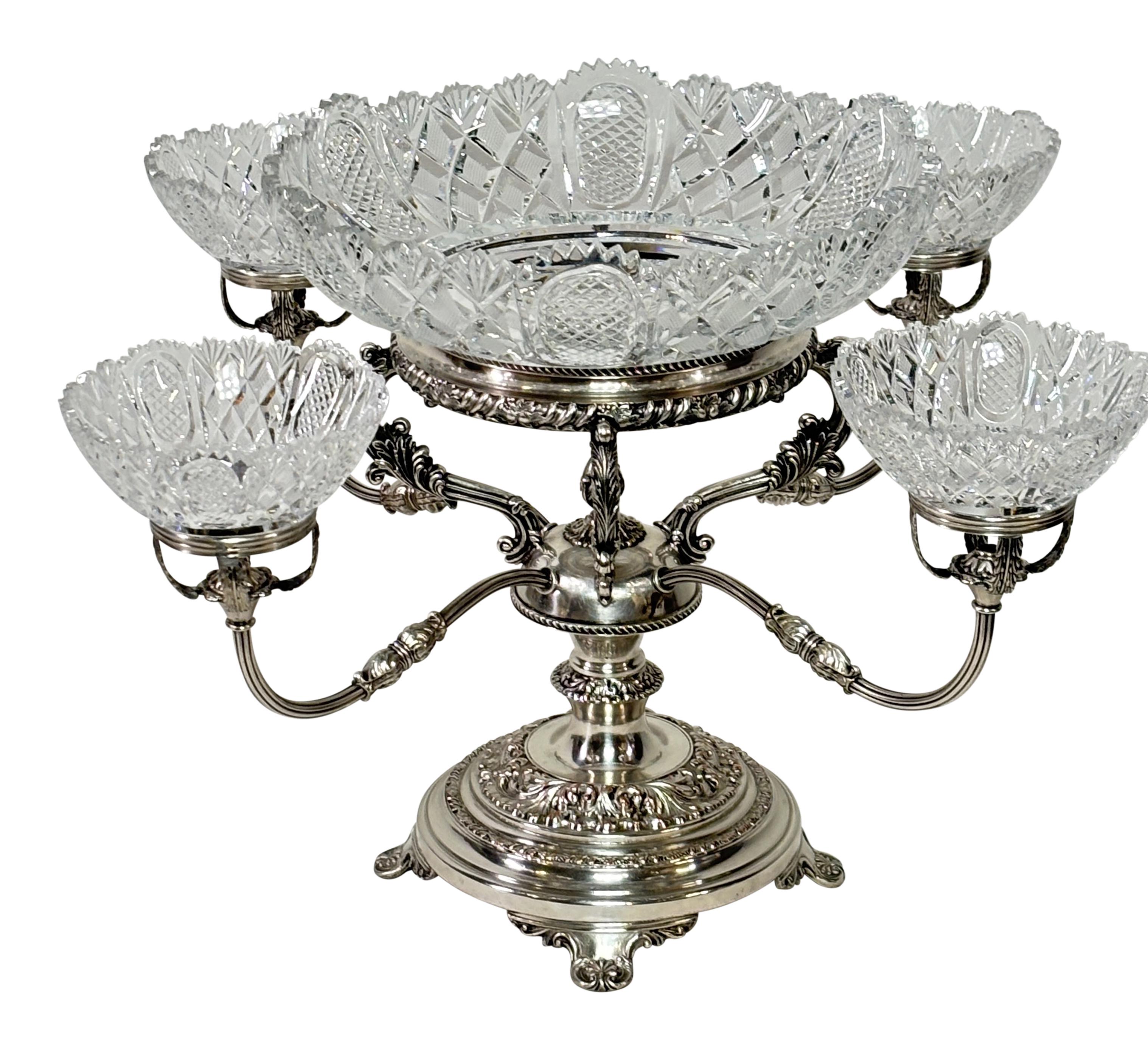 A large English Georgian period Sheffield silver-plate epergne centerpiece with a large centered cut glass bowl and four smaller surrounding bowls.
Beautiful quality and presence.
In excellent original condition.
Early 19th century.
