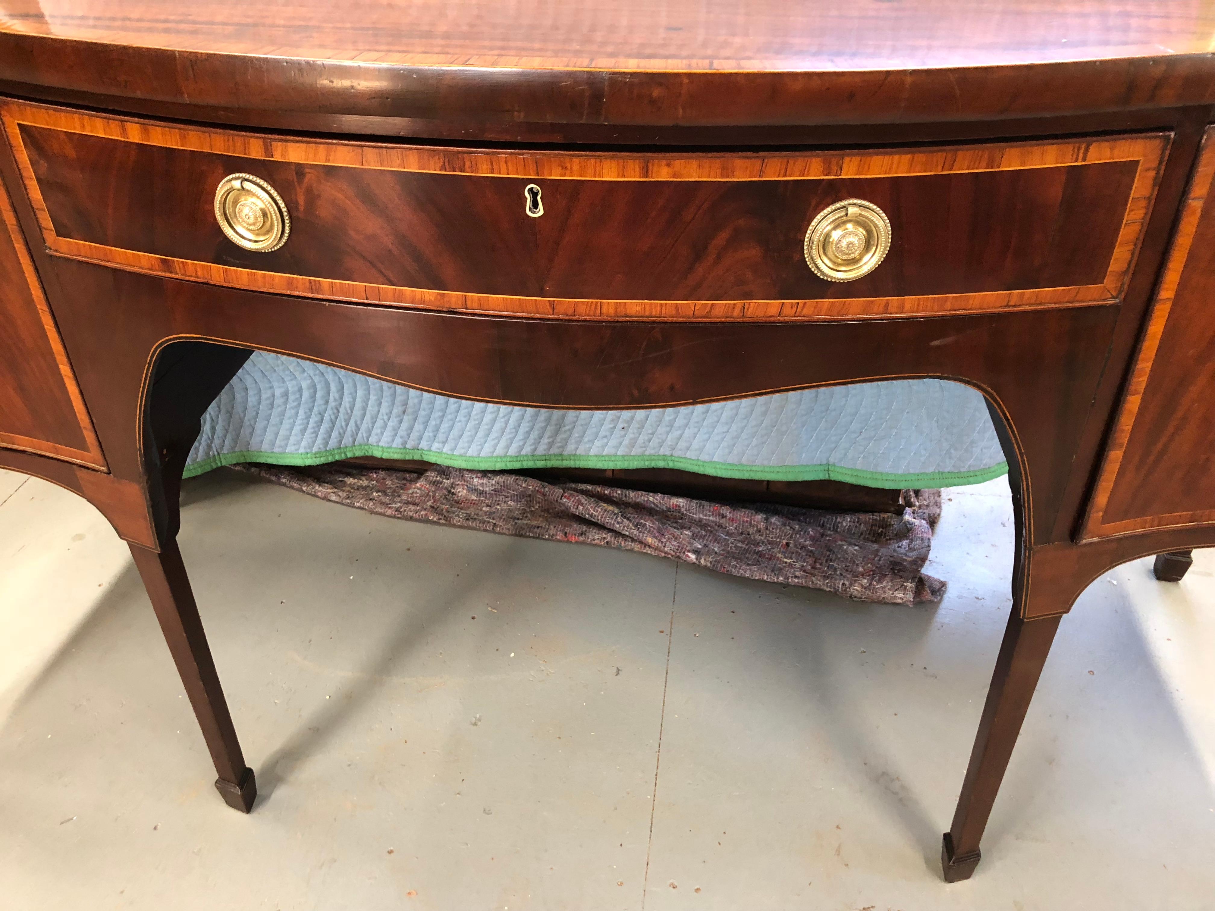 English Georgian Sideboard in mahogany with banded rosewood edge, banded drawers in satin wood, 2 deep wine drawers, 1 center drawer, all lined in felt, excellent color and wood grain, nice tapered legs, very original and beautiful.