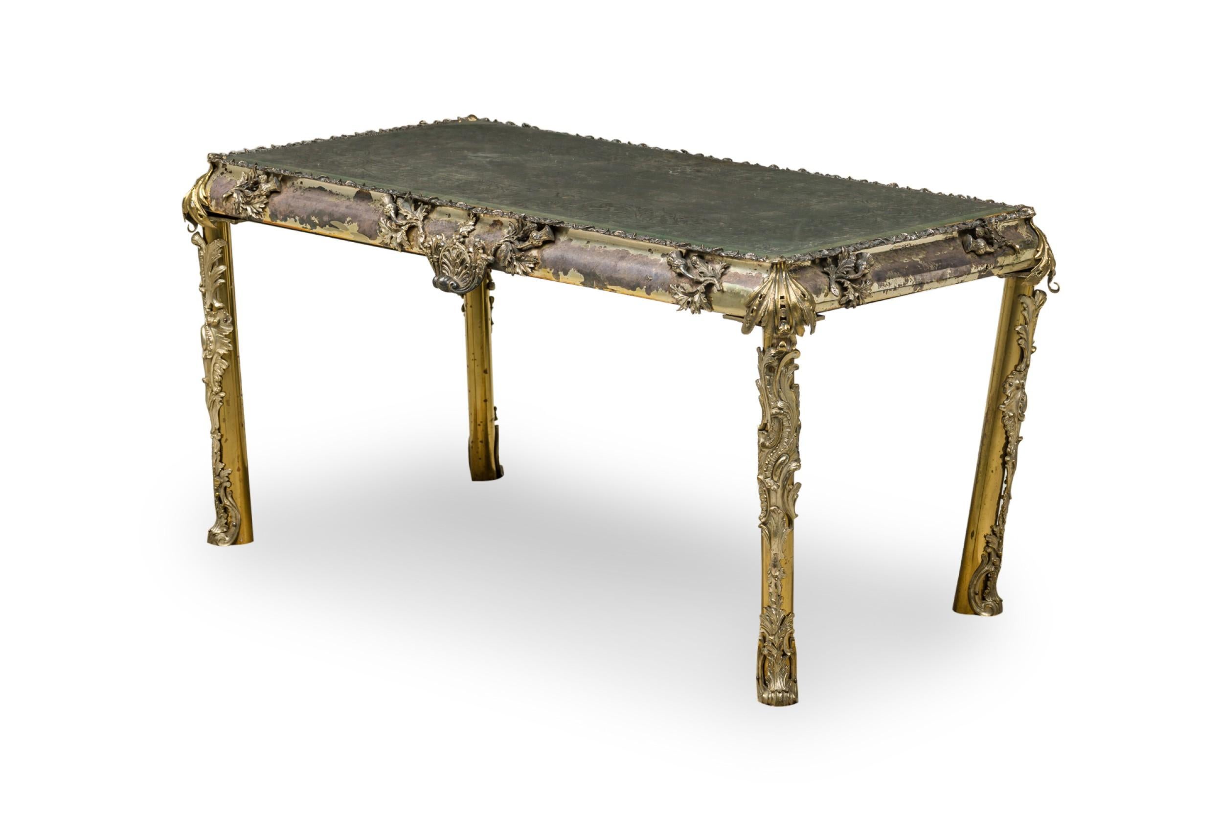 English Georgian (19th Cent) rectangular coffee / low table with an elaborately cast silver plate and bronze frame and an antique etched floral and scroll design mirrored top.
 

 Oxidation, tarnishing, and losses to table surface, one leg bent