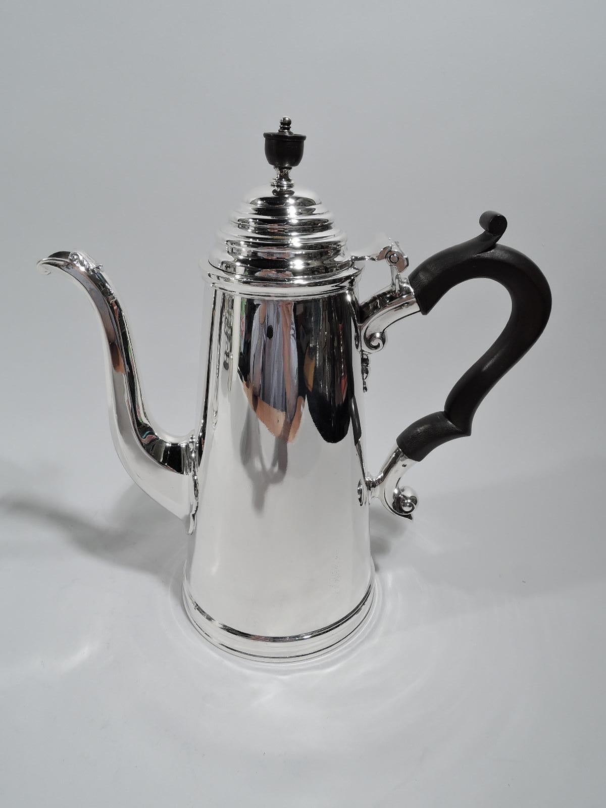 Pair of English Georgian silver café au lait pots. Made by James Dixon & Sons in Sheffield 1936-7. Each: Conical body and stepped and domed hinged cover with stained-wood vasiform finial. Capped stained-wood double-scroll handle. The coffeepot has a