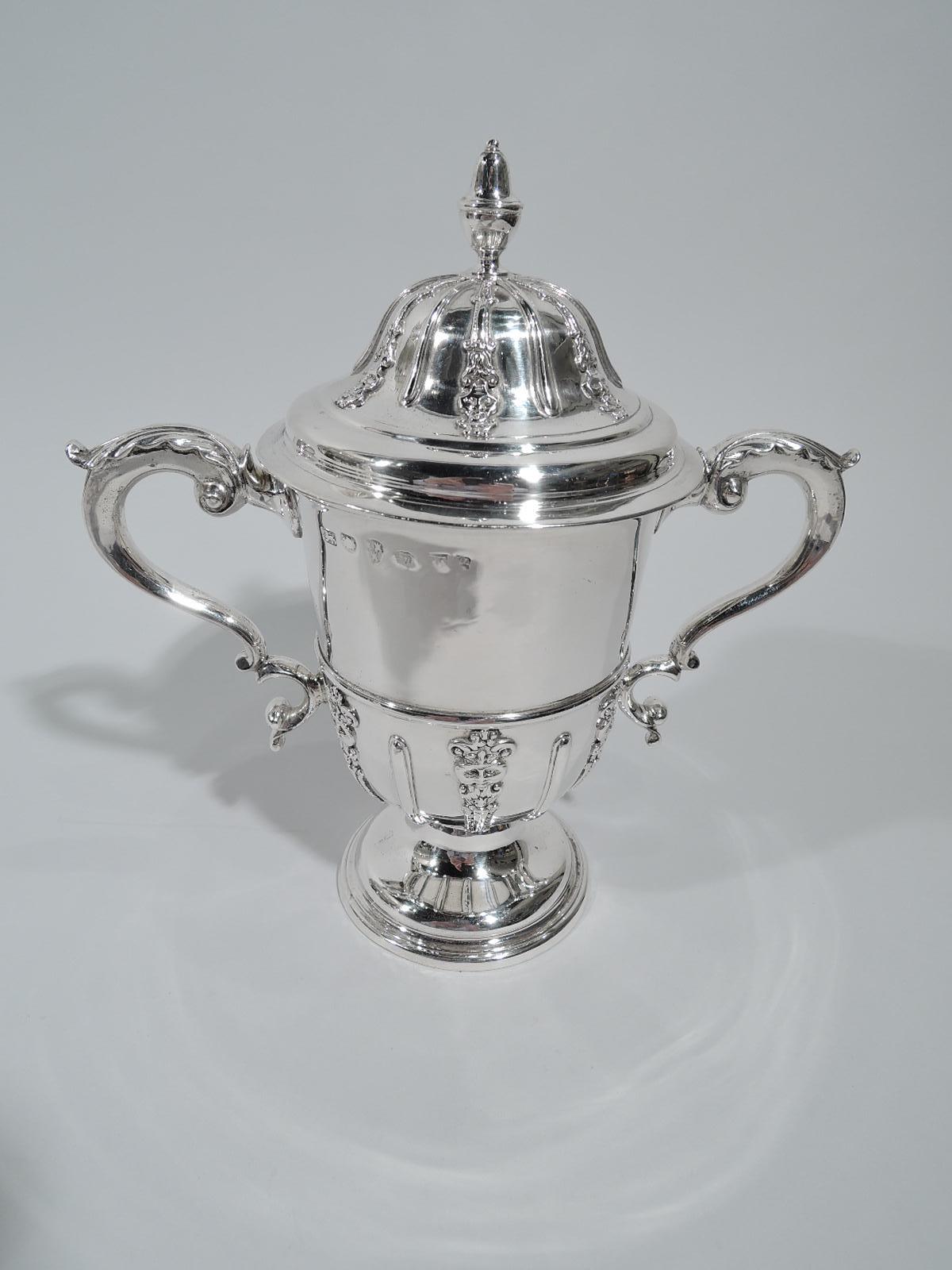 George II sterling silver covered urn. Made by John Langlands & John Robertson in Newcastle in 1739. Girdled with leaf-capped double-scroll sides handles and raised foot. Cover domed with acorn finial. Applied vertical strapwork alternating with
