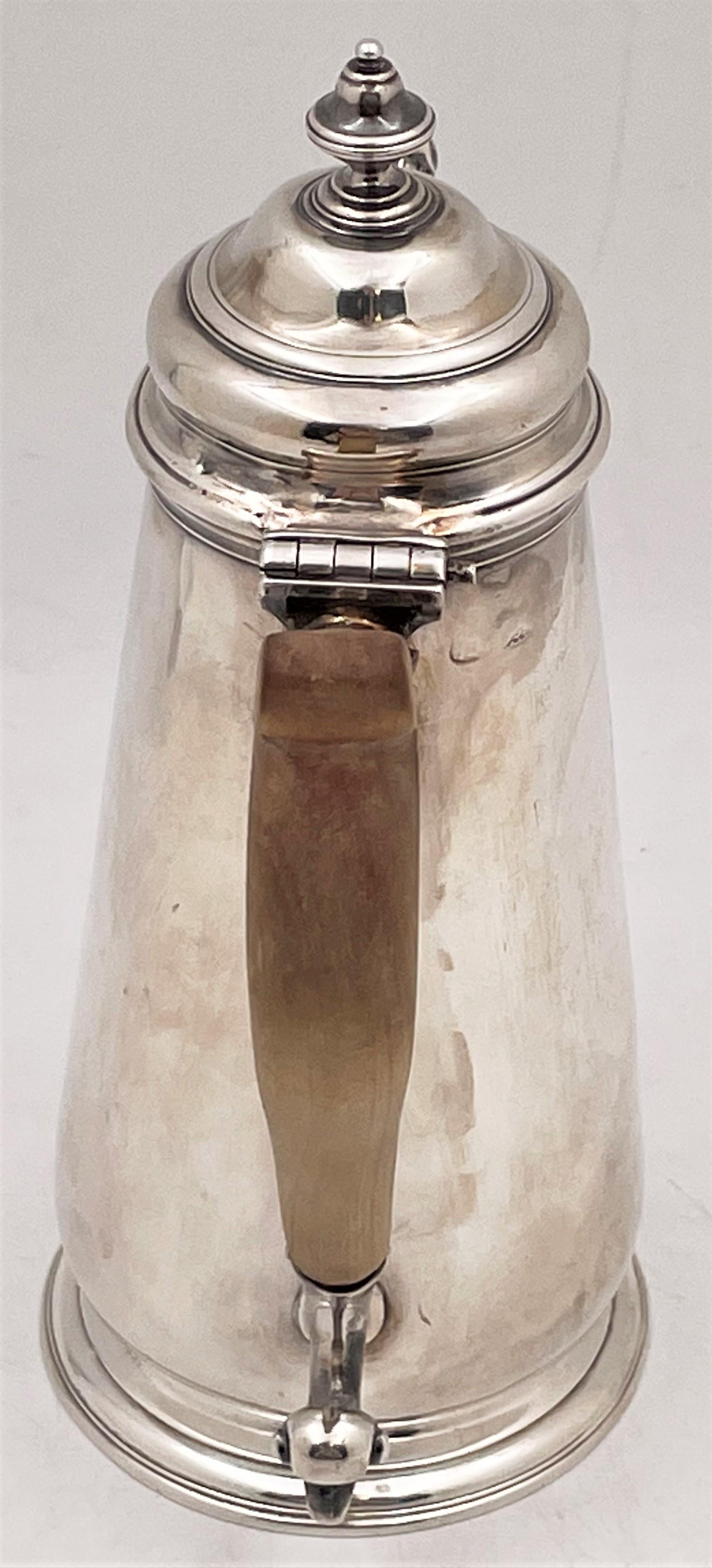 English, sterling silver coffee pot from the Georgian era (late 18th/early 19th century) with a wood handle. It measures 8 1/8'' in height by 6 3/4'' from handle to spout, weighs 14.2 troy ounces, and bears faint hallmarks as shown.

Please feel