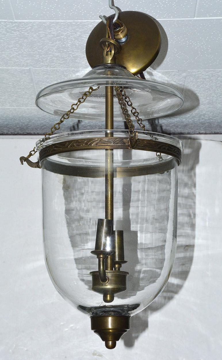 Vintage English Georgian style clear glass hanging pendant lantern suspended by chains from a glass cover and brass ring. Two light interior cluster lights. Bell Jar hanging chandelier or hall light. It arrives ready to install with brass ceiling
