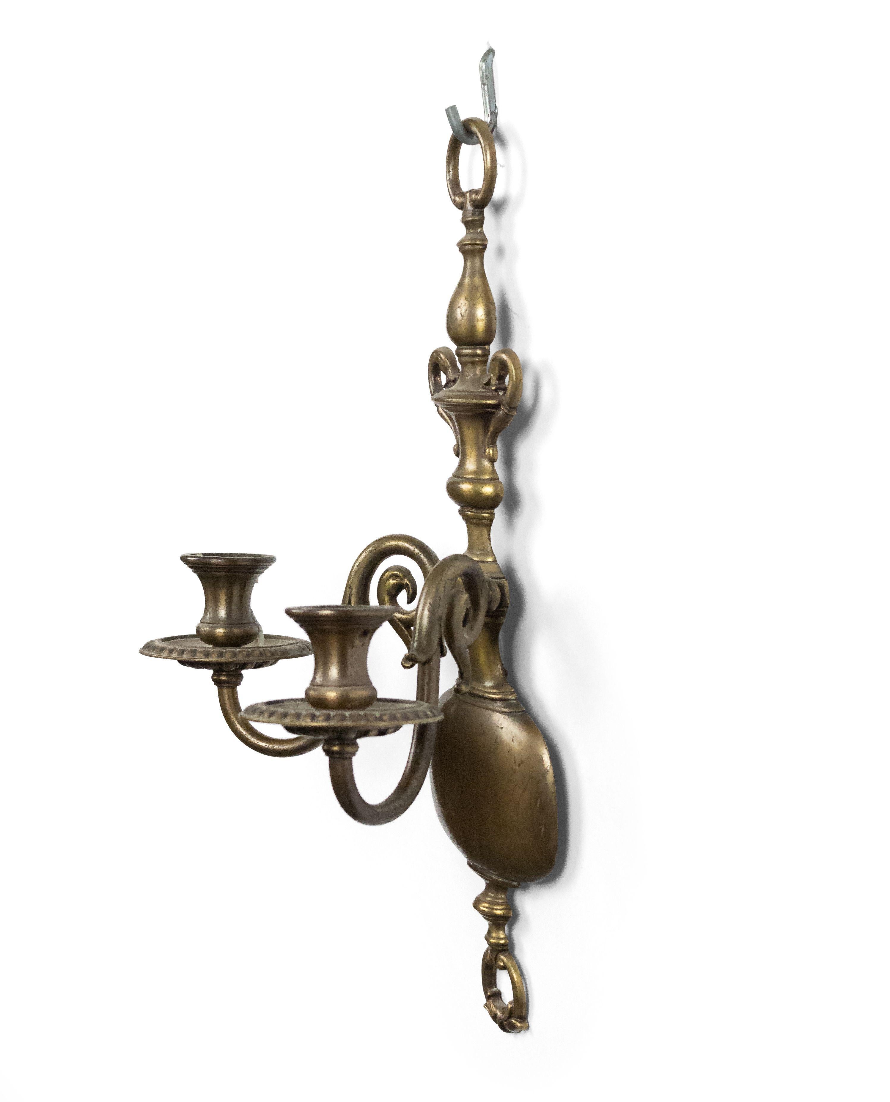 Pair of English Georgian style brass 2 arm wall sconces with vasiform backplate, 20th century.