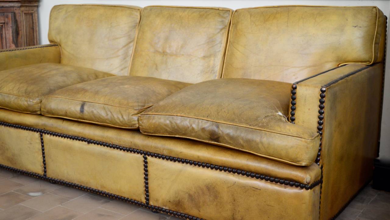 A very elegant English leather library three-seat sofa.
Cushions are feather filled and the sofa is strong and comfortable for everyday use. Beautiful patina achieved from age and use.
 