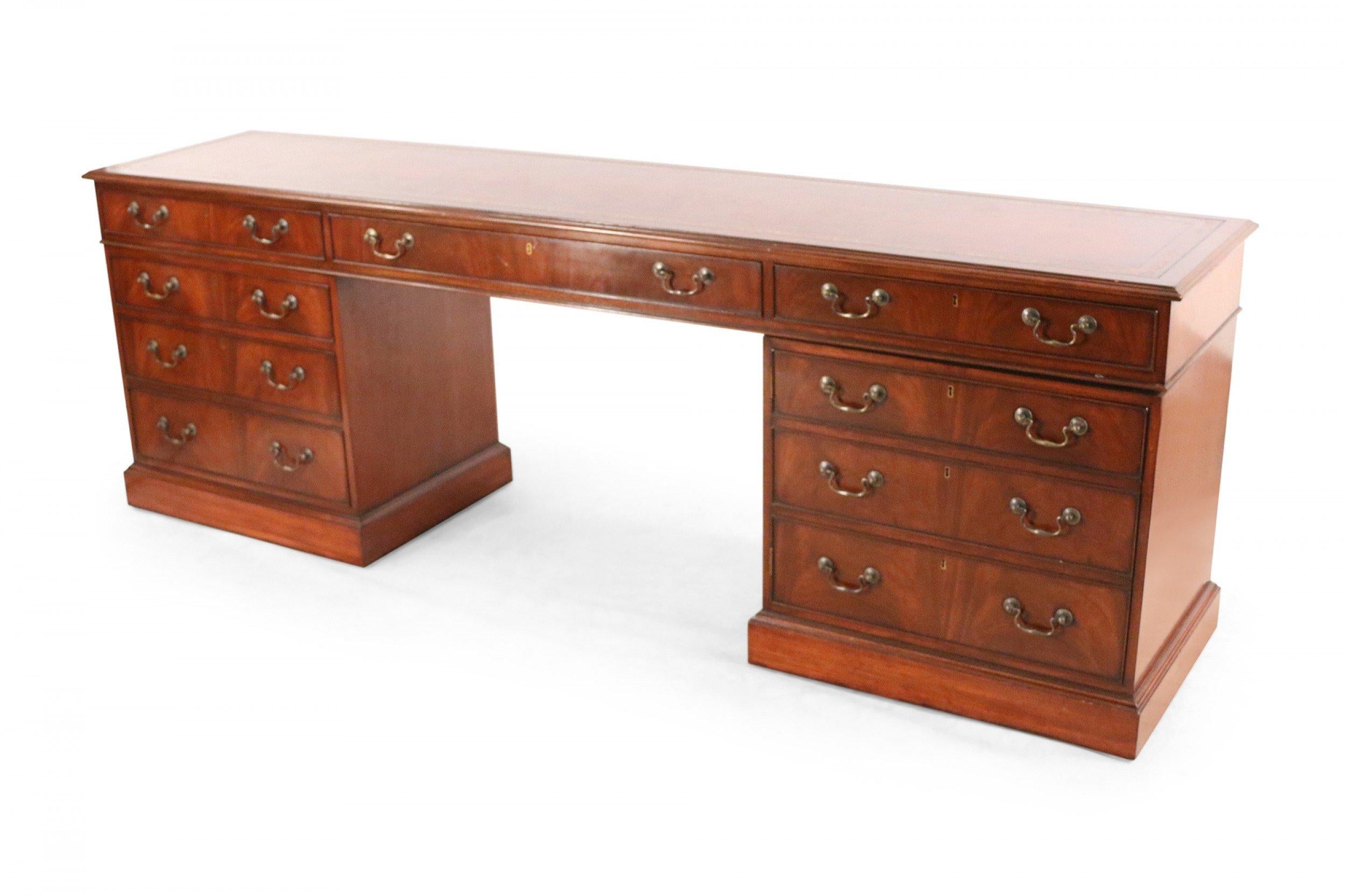 English Georgian-style (19th century) mahogany desk with a long, slim profile with six drawers and brass drawer pulls.