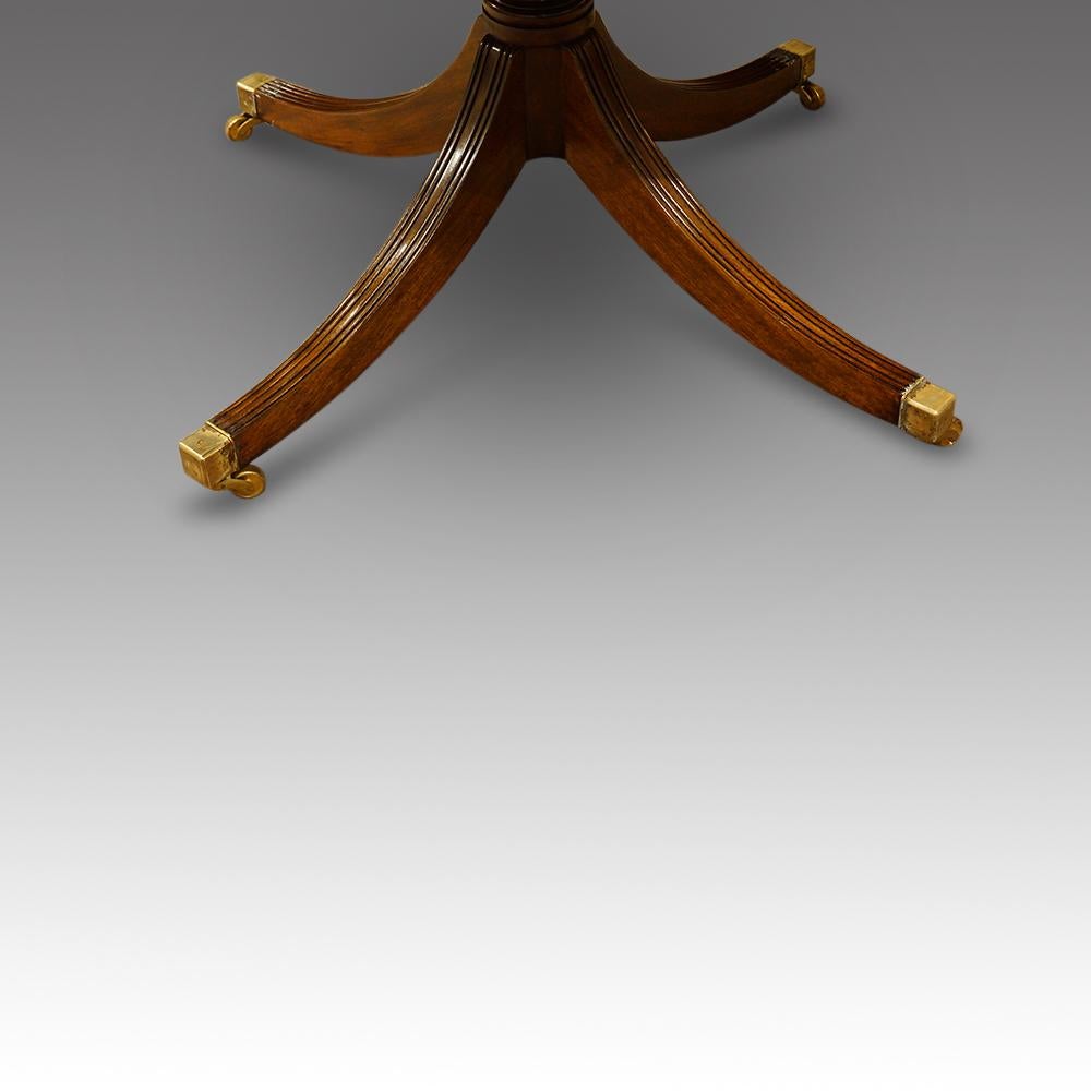 Georgian style mahogany dining table
This Georgian style mahogany dining table was retailed by Harrods.
The table stands on a pair of mahogany quadruple splay legged pedestals with turned gun barrel columns with each leg having square brass toe
