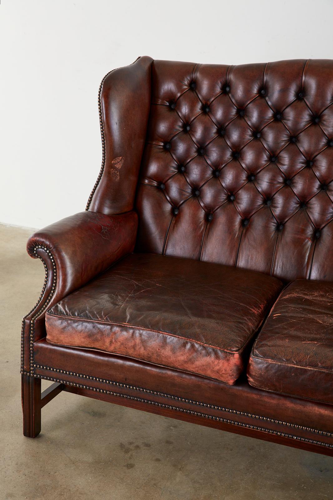 English Georgian Style Tufted Leather Chesterfield Wingback Settee In Distressed Condition In Rio Vista, CA