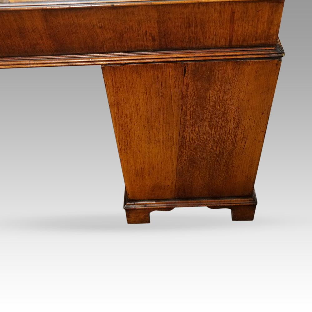 Georgian style walnut pedestal desk
This fine quality Georgian style walnut pedestal desk was made circa 1910.
It is a rare design with the stepped top above the pedestals below. A lovely walnut moulding runs around the waist, made in sections of