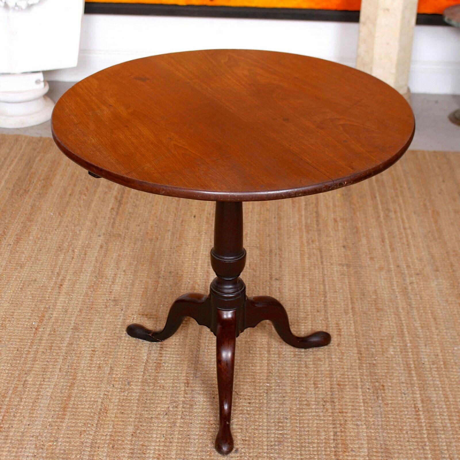 An impressive 19th century mahogany tripod table.

The circular top raised on a carved raised on a turned tapering barrel column with tripartite legs and pad feet.

Repair to one leg.

England, circa 1820.
  