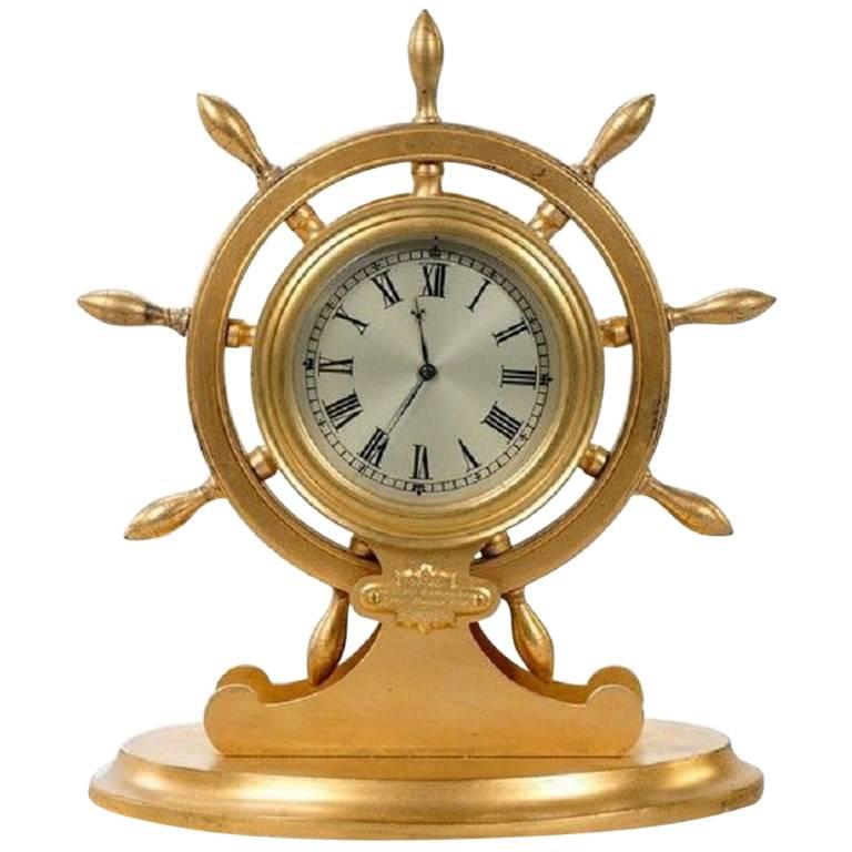 Orologio da tavolo inglese con ruota di nave in metallo dorato