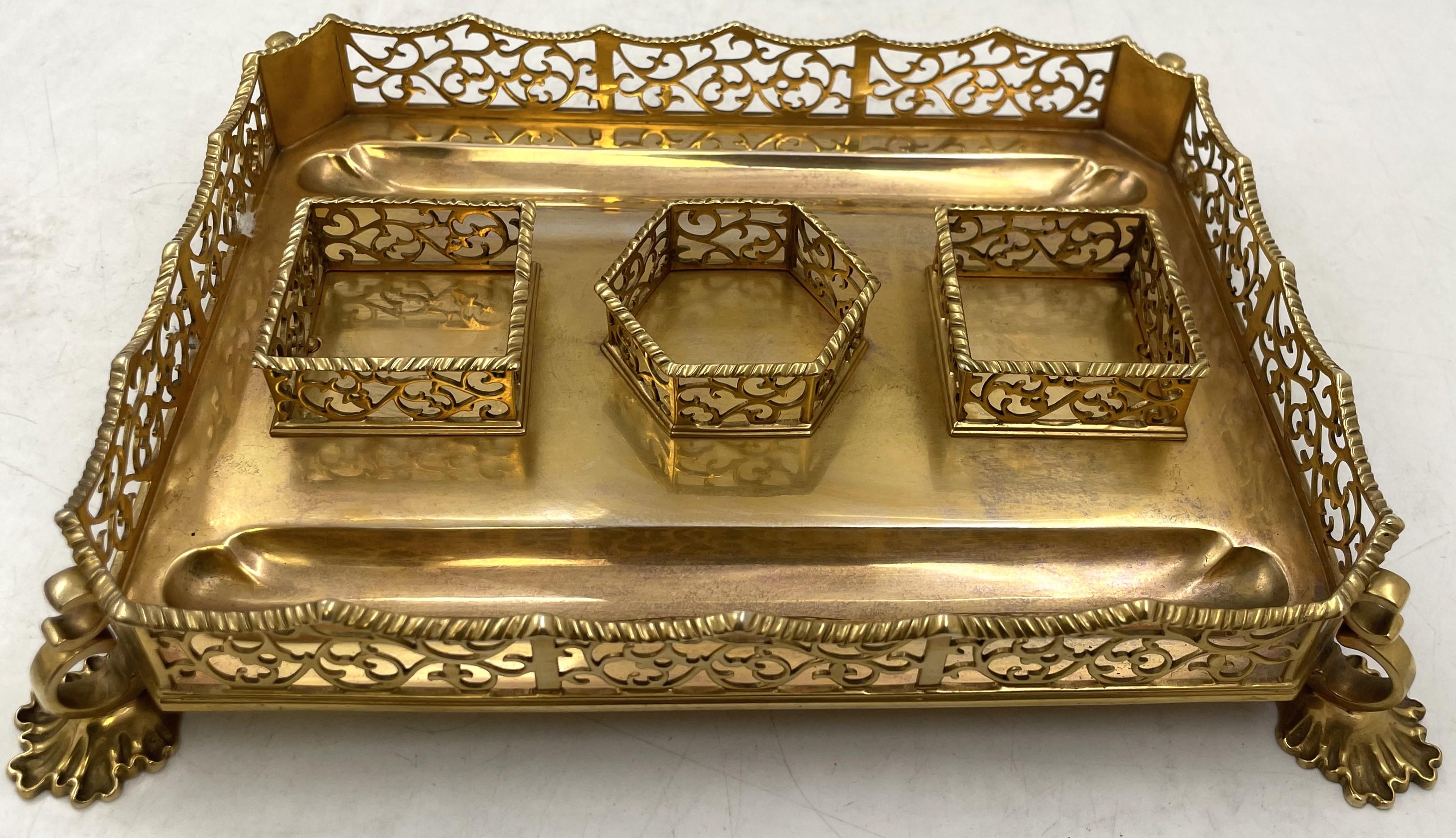 English gilt sterling silver inkstand with two glass and gilt sterling silver inkwells with pierced motifs, from 1844 (Victorian era).  It measures 9'' in depth by 6 3/4'' in depth by 3 3/4'' in height, weighs 17.9 troy ounces (excluding the glass