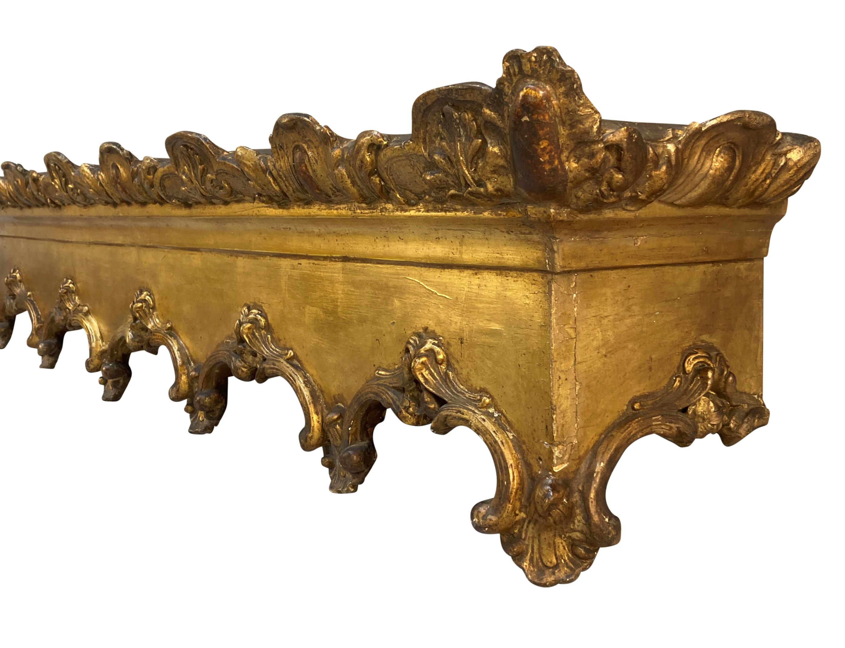 An English carved giltwood Gothic pelmet.
