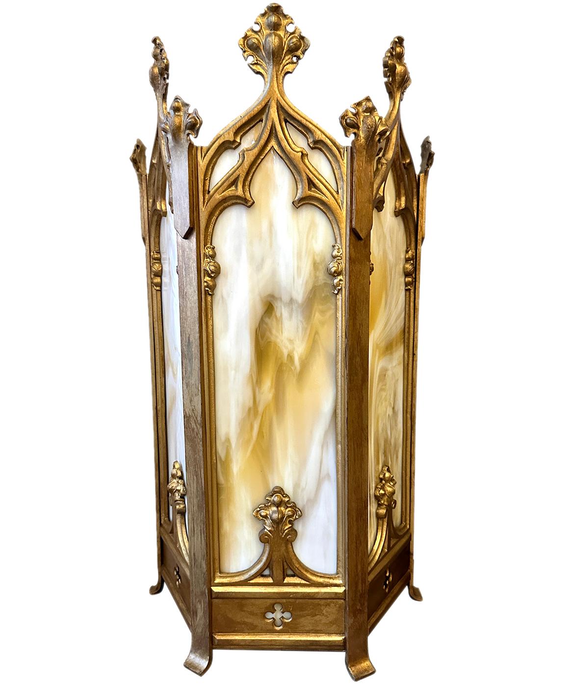 Pair of large 1930s English Gothic style gilt bronze sconces with original slag glass panels.

Measurements:
Height 25.25