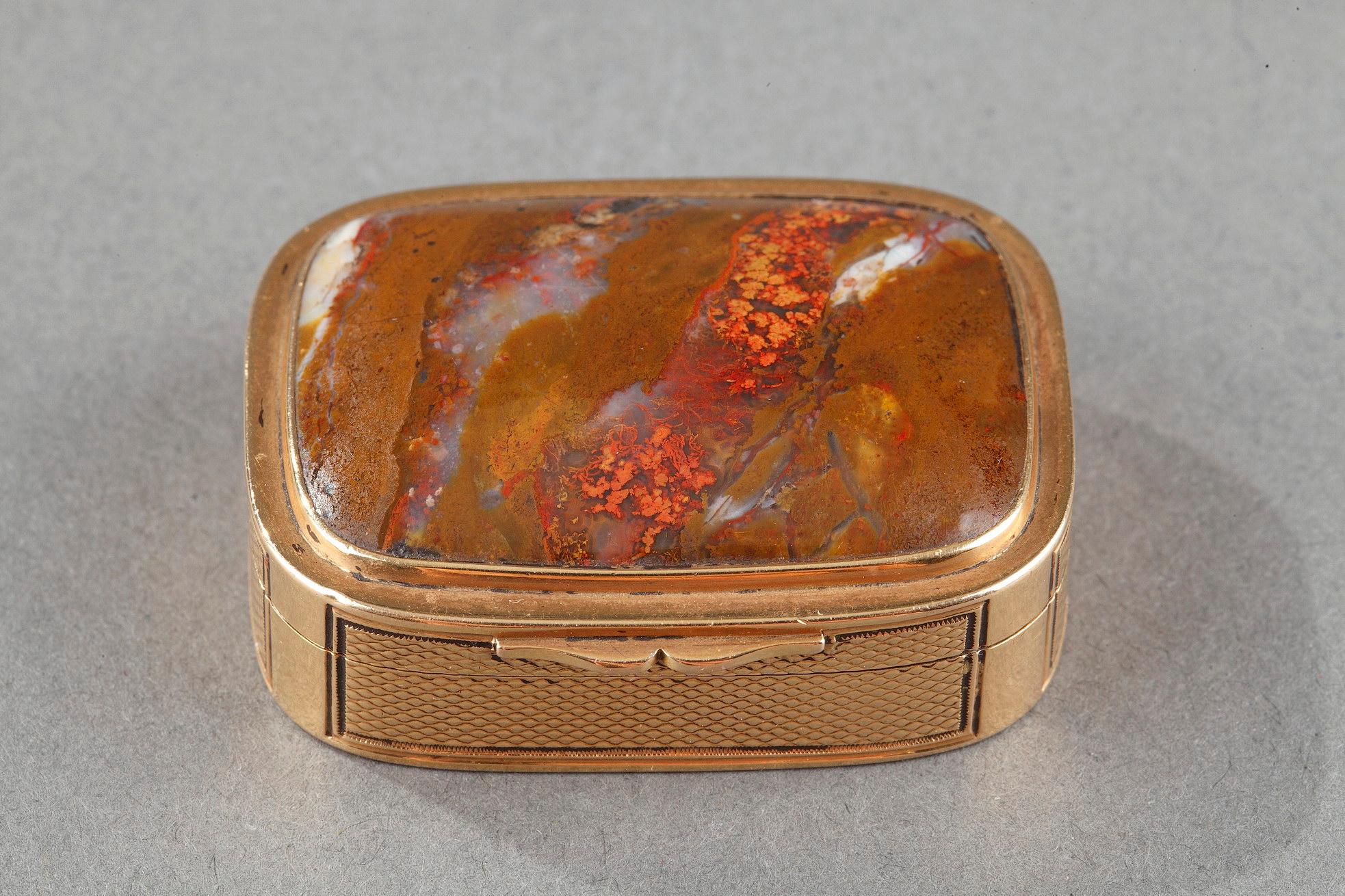Small handbag or pills box in gold and agate. The boat and the bottom are finely guilloché with geometrical motif. The hinged lid is set with an agate with golden reflections.

Measures: W: 1,55 oz (44gr)

L: 1,57in. (4 cm) / L: 1,18 in.(3 cm)/