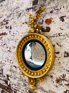 English Gold Gilt Convex Mirror with Eagle on Plinth and Lion at Base