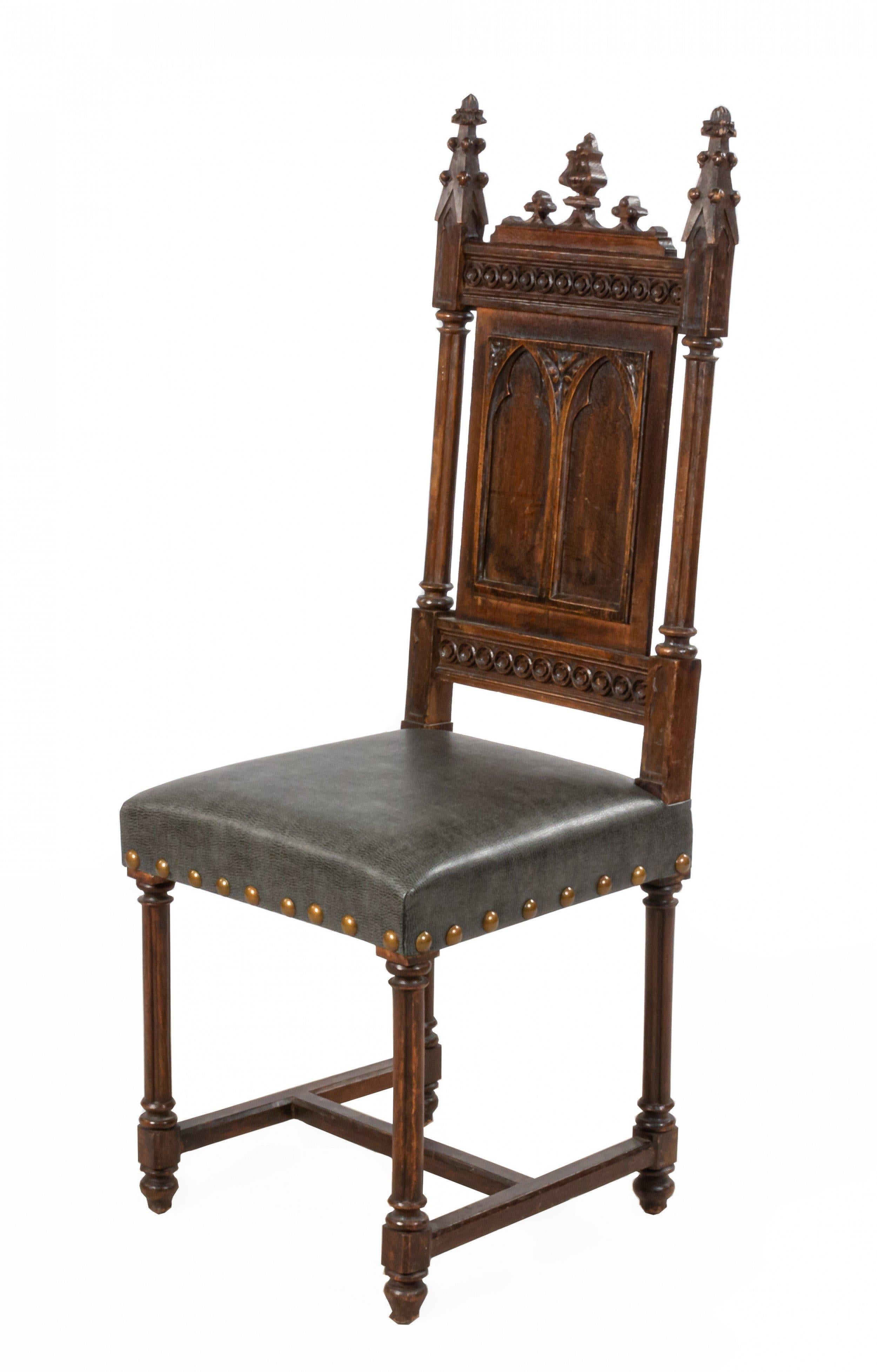 Set of 11 English Gothic Revival style (19th Century) oak side panel back side chairs with finials and gray leather seats.