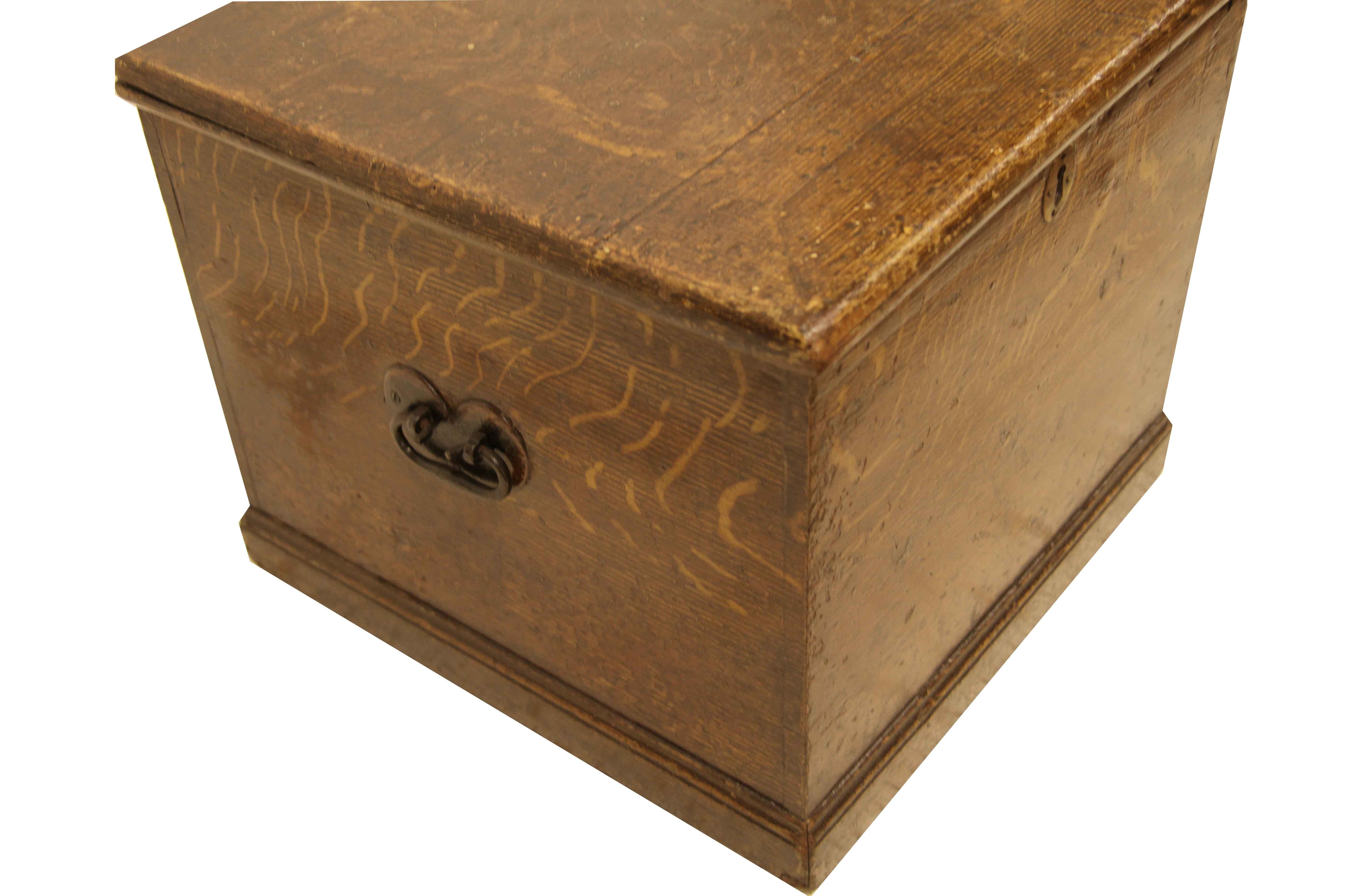 English grain painted box, this nearly square box is painted on all sides to simulate quarter sawn oak. It retains the original steel carrying handles on the sides. The interior and lid have been papered(can be removed on request); the top is