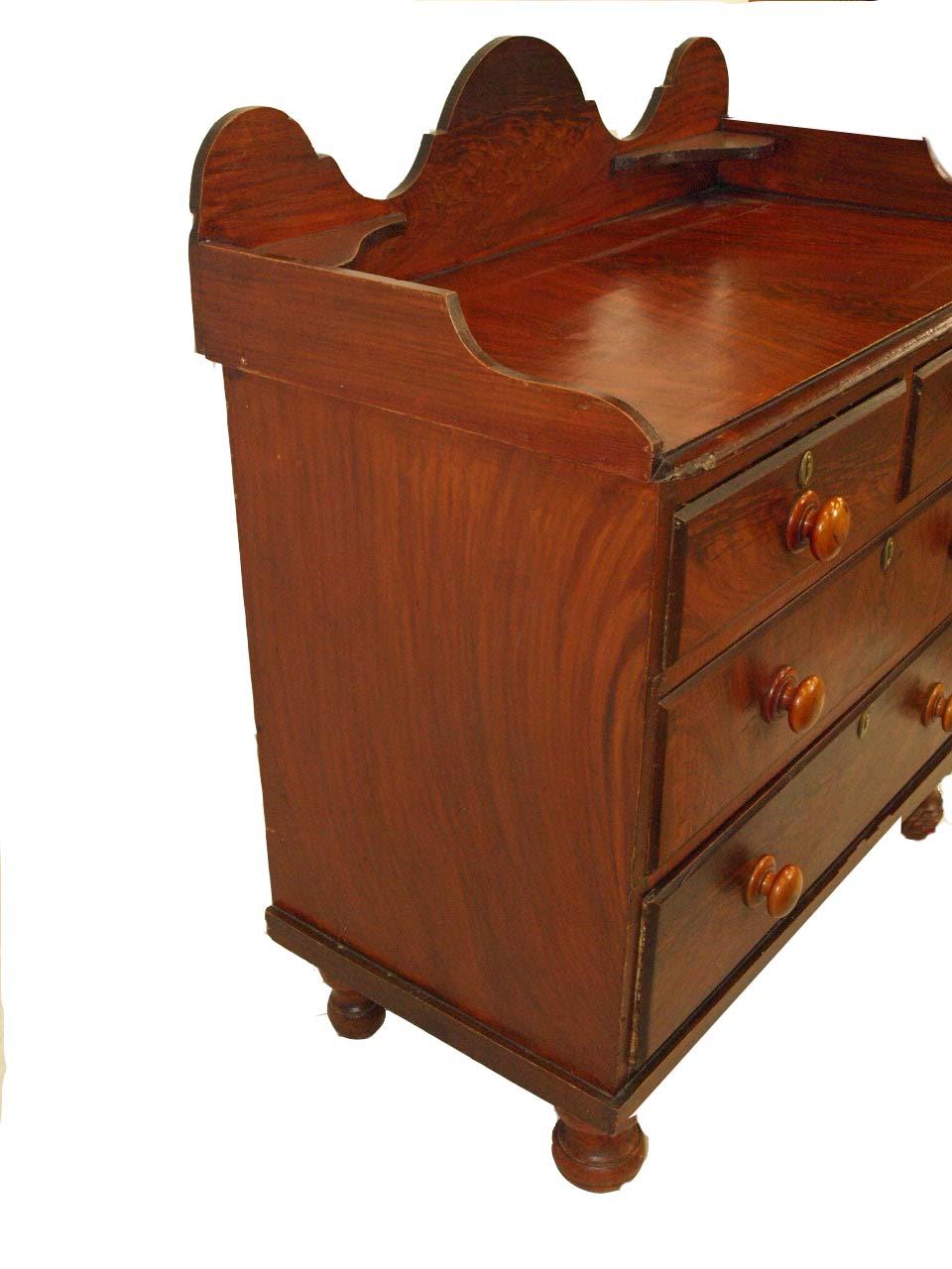 English grain painted two over three drawer chest, with gallery surrounding the top, drawers with original beech wood knobs; resting on turned feet.  The surface height is 31'' and the gallery back adds an additional 8.25''.